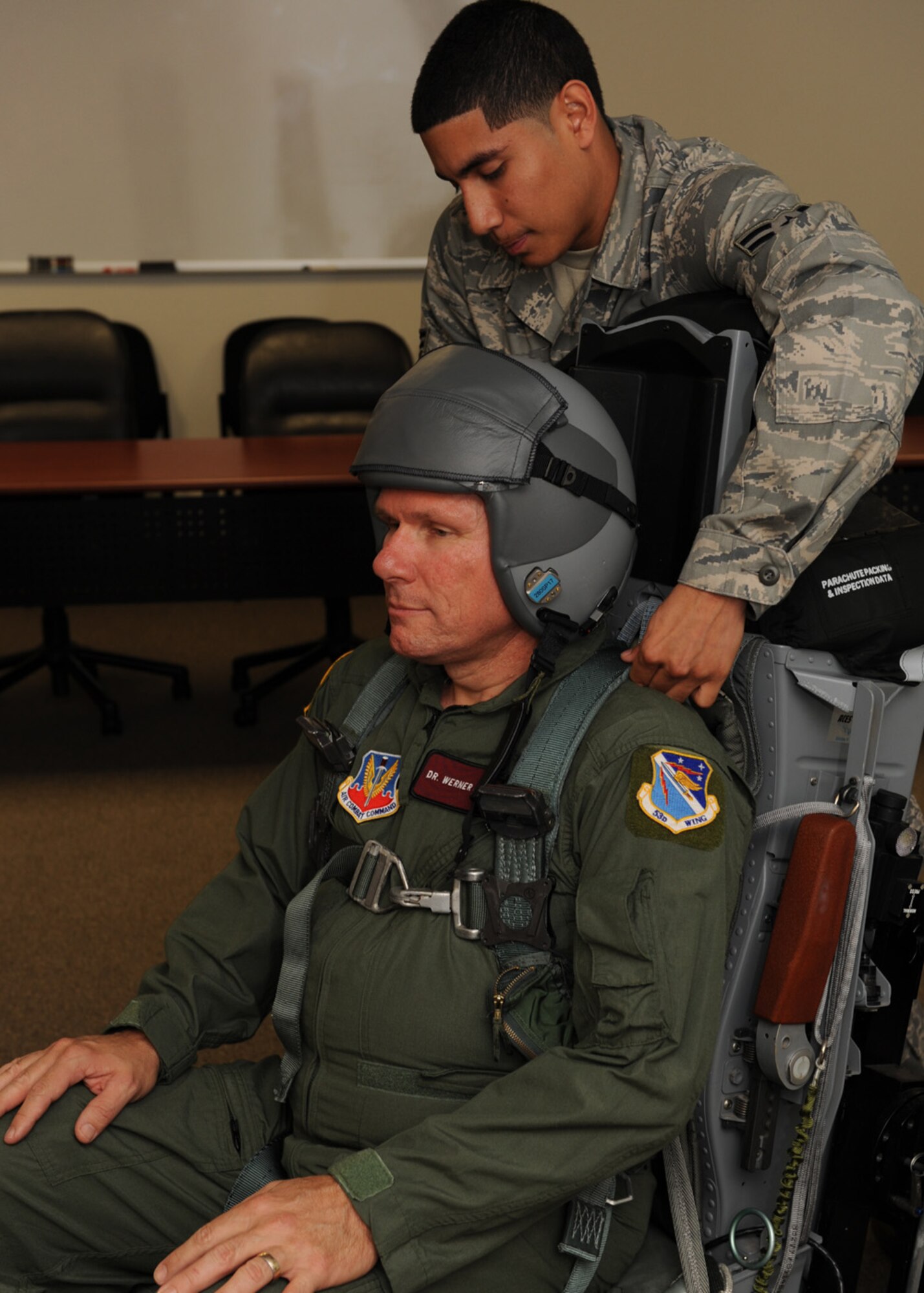 DYESS AIR FORCE BASE, Texas—Dr. Werner Dahm, Chief Scientist of the Air Force, gets his flight harness fitted by Airman 1st Class Phillip Caicedo, 7th Operations Support Squadron, Sept. 12 here.  Dr. Dahm received an incentive flight on the B-1 Lancer while visiting Dyess. (U.S Air Force photo by Senior Airman Jennifer Romig)