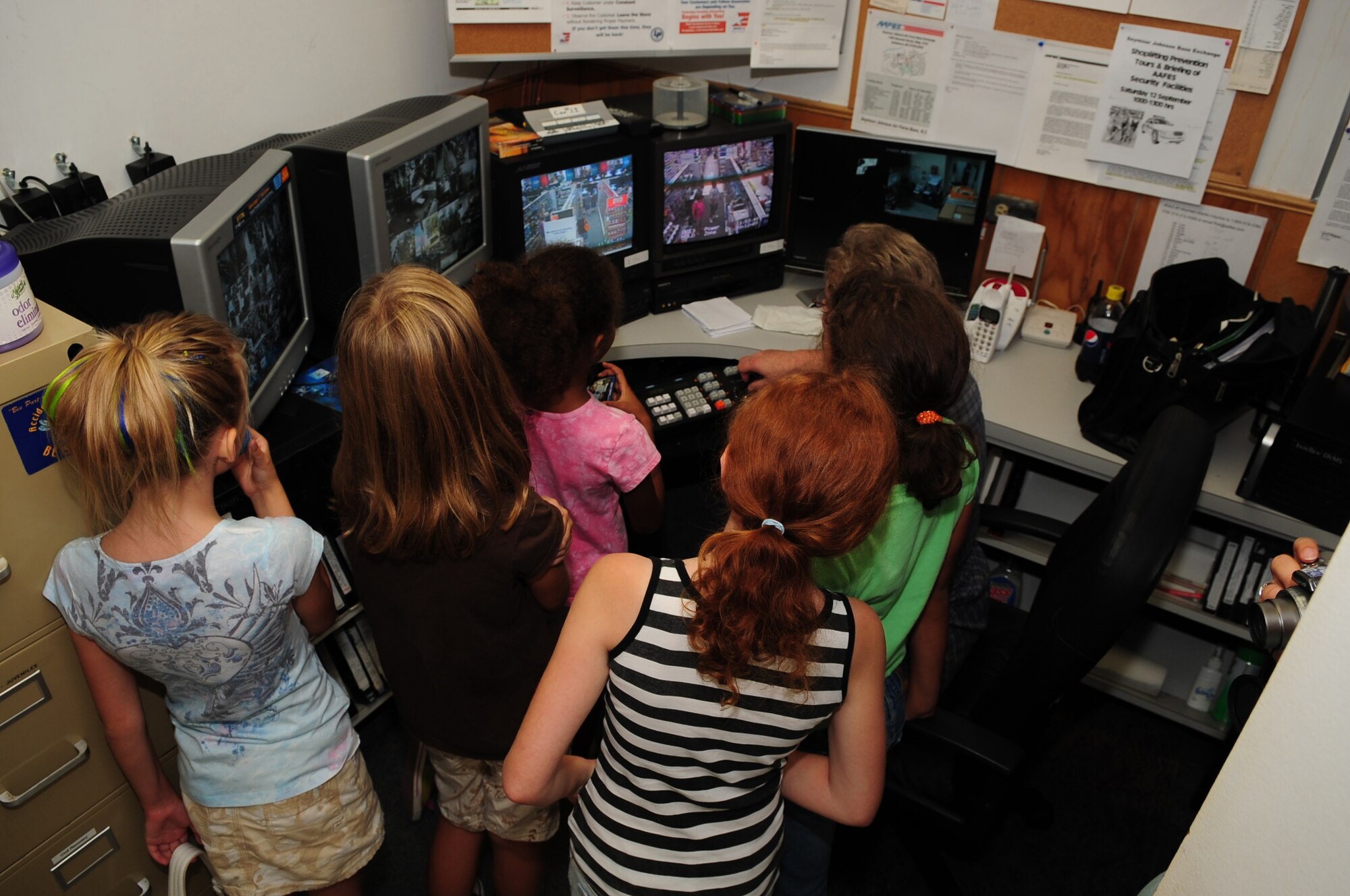 Military children watch security camera screens in the Base Exchange during a shoplifting prevention event on Seymour Johnson Air Force Base, N.C., Sept 12, 2009. Attendees learned the process shoplifters go through after getting caught stealing from the BX. (U.S. Air Force photo by Airman 1st Class Kevin Kegney)