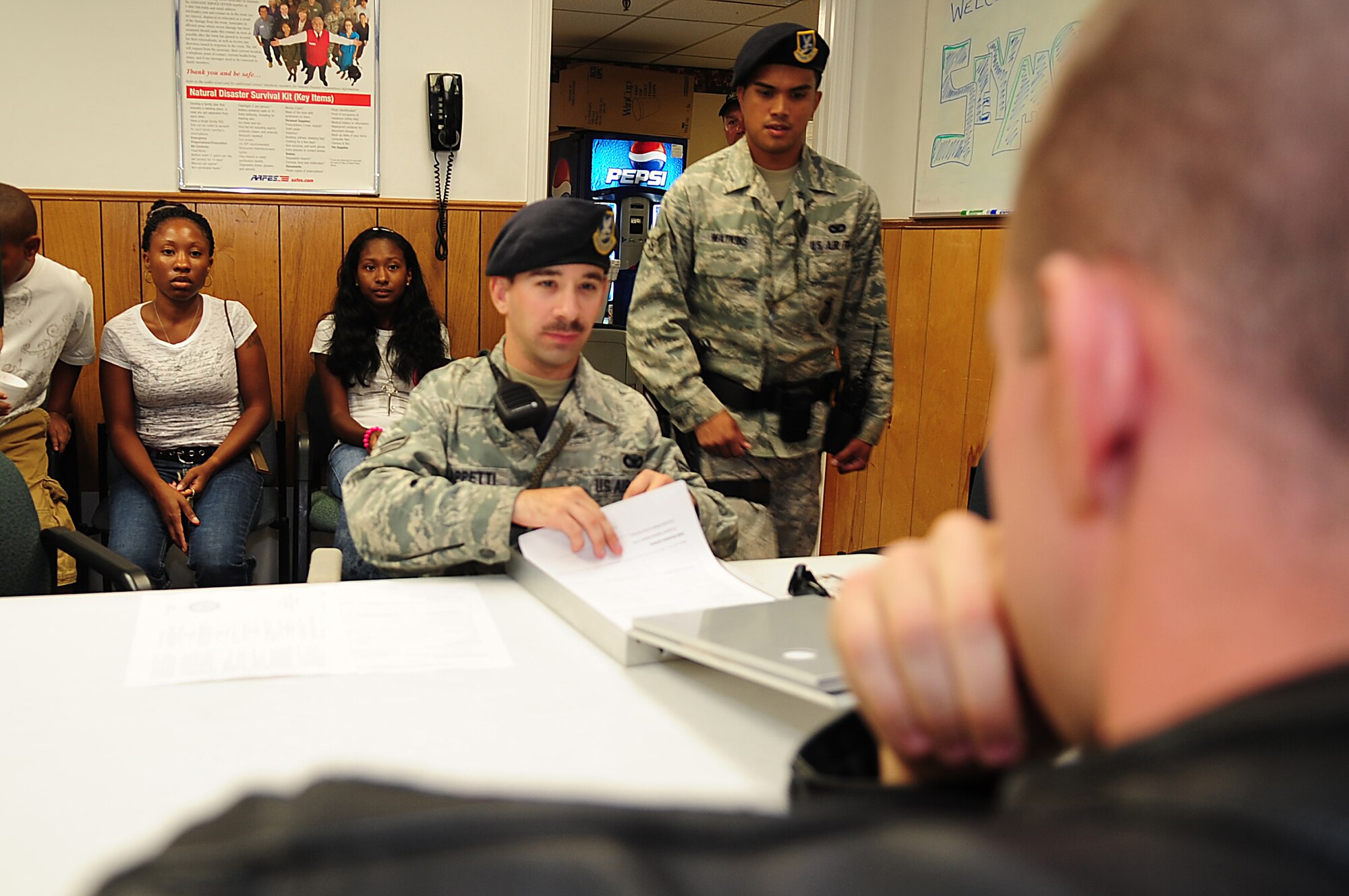 Senior Airman Adam Cappetti and Airman 1st Class Matthew Watkins, 4th Security Forces Squadron patrolmen, question a suspected shoplifter during a Shoplifting Prevention event scenario at the Seymour Johnson Base Exchange, Sept. 12, 2009.  The event showed the consequences of shoplifting to youths. (U.S. Air Force photo by Airman 1st Class Rae Perry)
