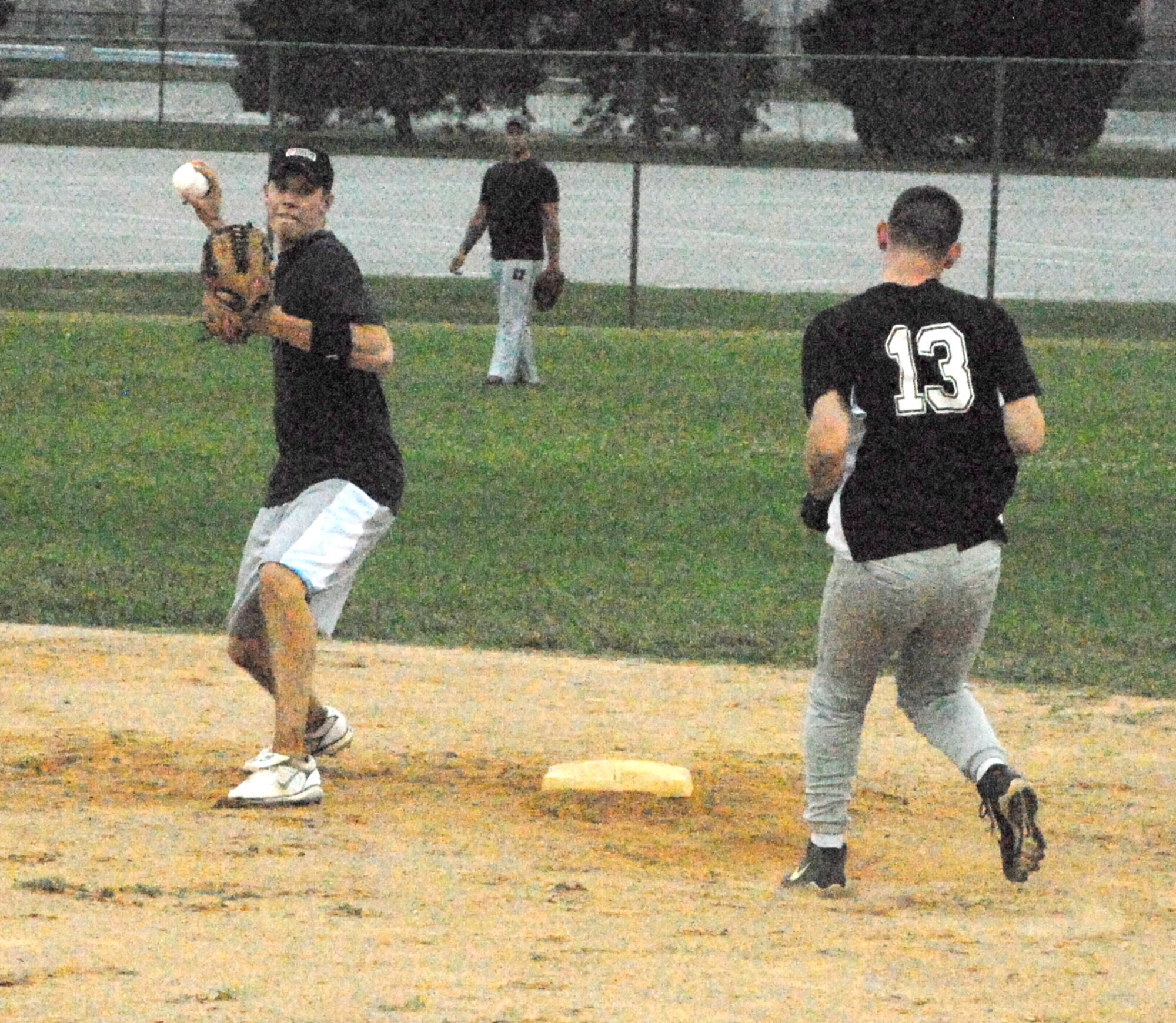 Lane Thurman, 436th Maintenance Squadron, prepares to throw the ball to first base to try and get a double play after tagging second base, forcing out a 436th Security Forces Squadron runner during an intramural championship game Sept. 15.  The 436th MXS defeated the 436th Security Forces Squadron 12 - 6 to win the intramural softball championship.   (U.S. Air Force photo/Staff Sgt. Chad Padgett) 