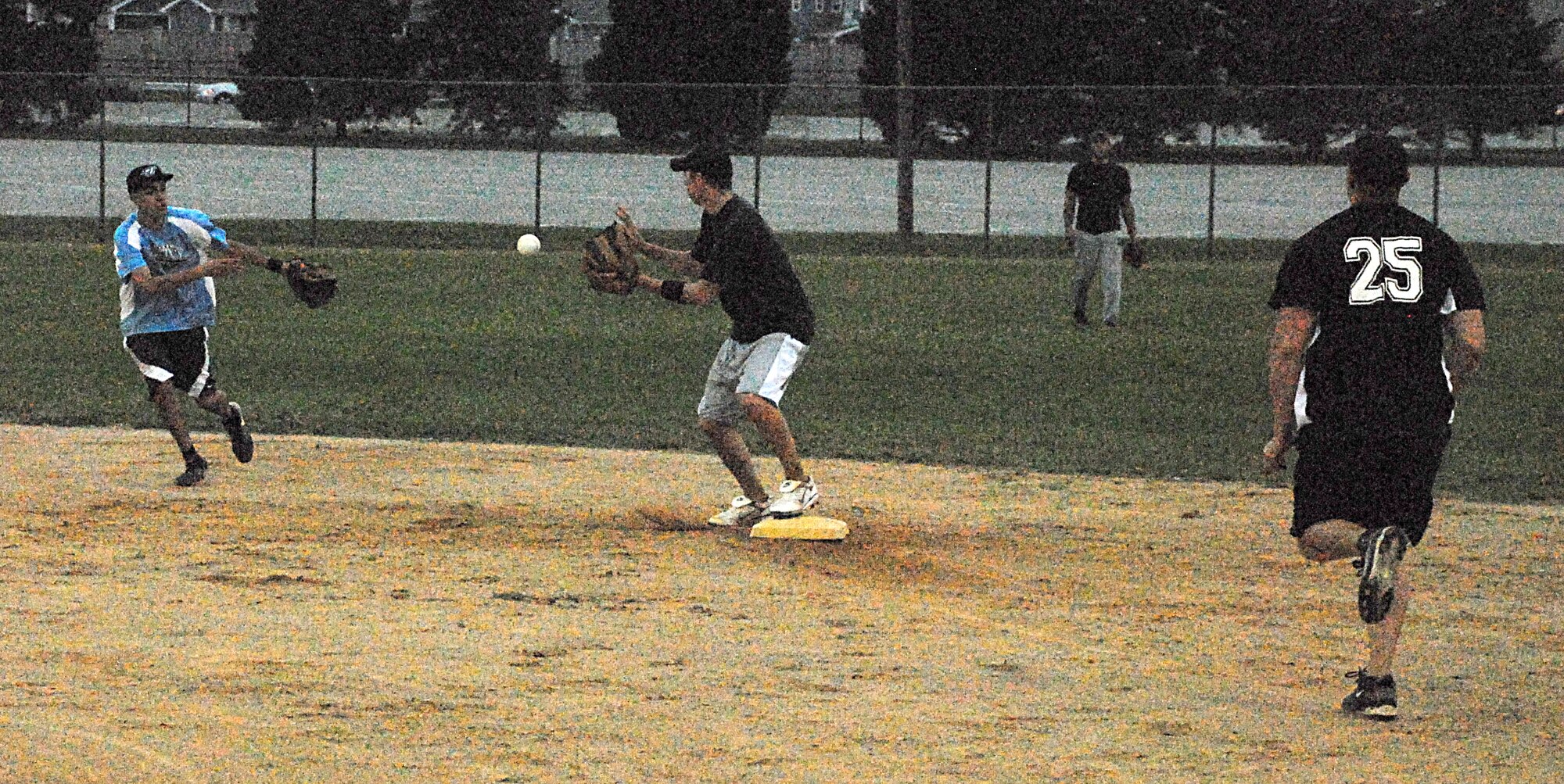 Anthony Arguello, 436th Maintenance Squadron shortstop, tosses the ball to Lane Thurman, 436th MXS second baseman, in time to force out 436th Security Forces Squadron runner, Mike Marsters, during the intramural softball championship game Sept. 15.  (U.S. Air Force photo/Staff Sgt. Chad Padgett)