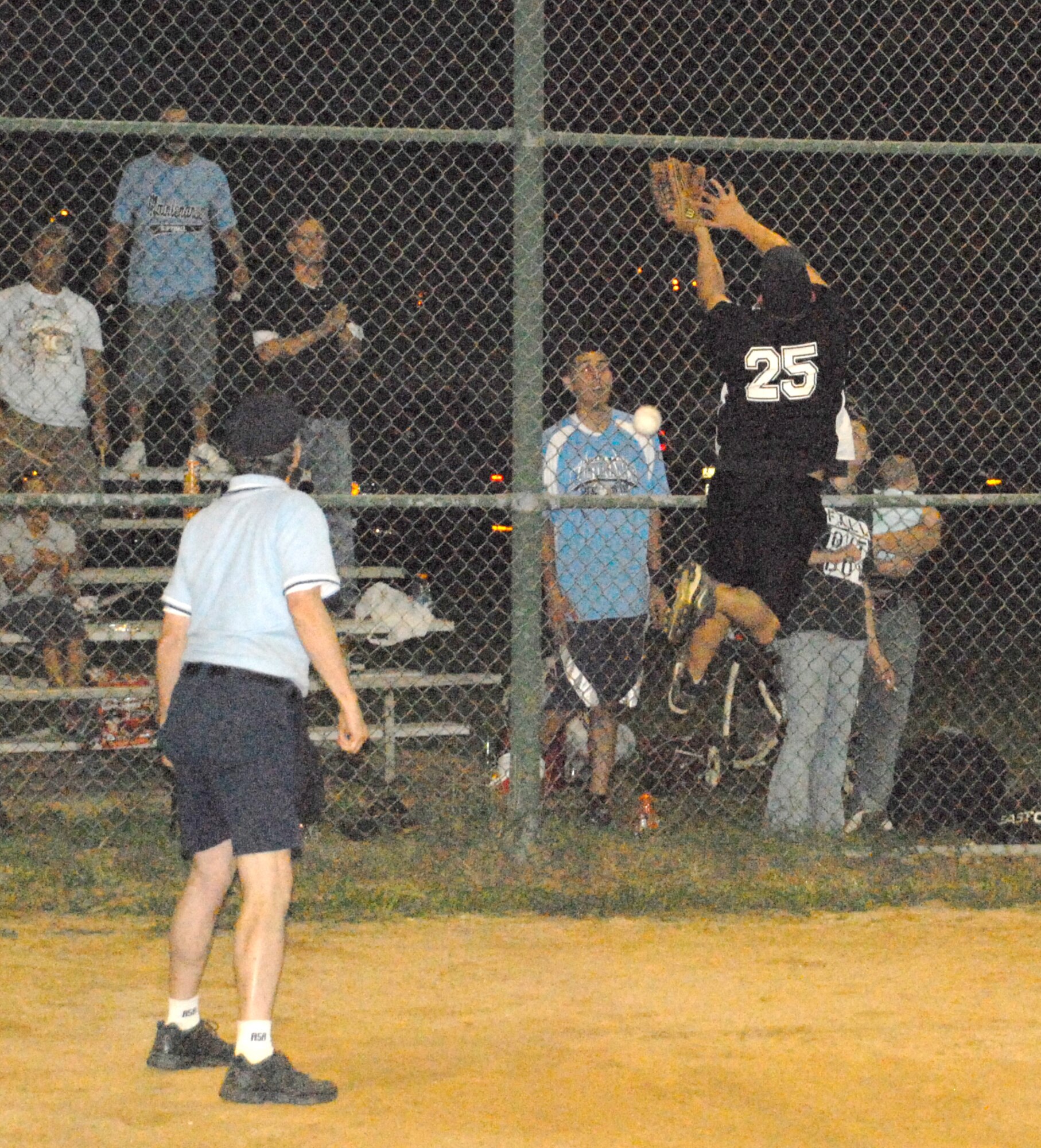 Mike Marsters, 436th Security Forces Squadron catcher, tries to catch a foul ball off the fence during the intramural championship softball game against the 436th Maintenance Squadron Sept. 15.  (U.S. Air Force photo/Staff Sgt. Chad Padgett)