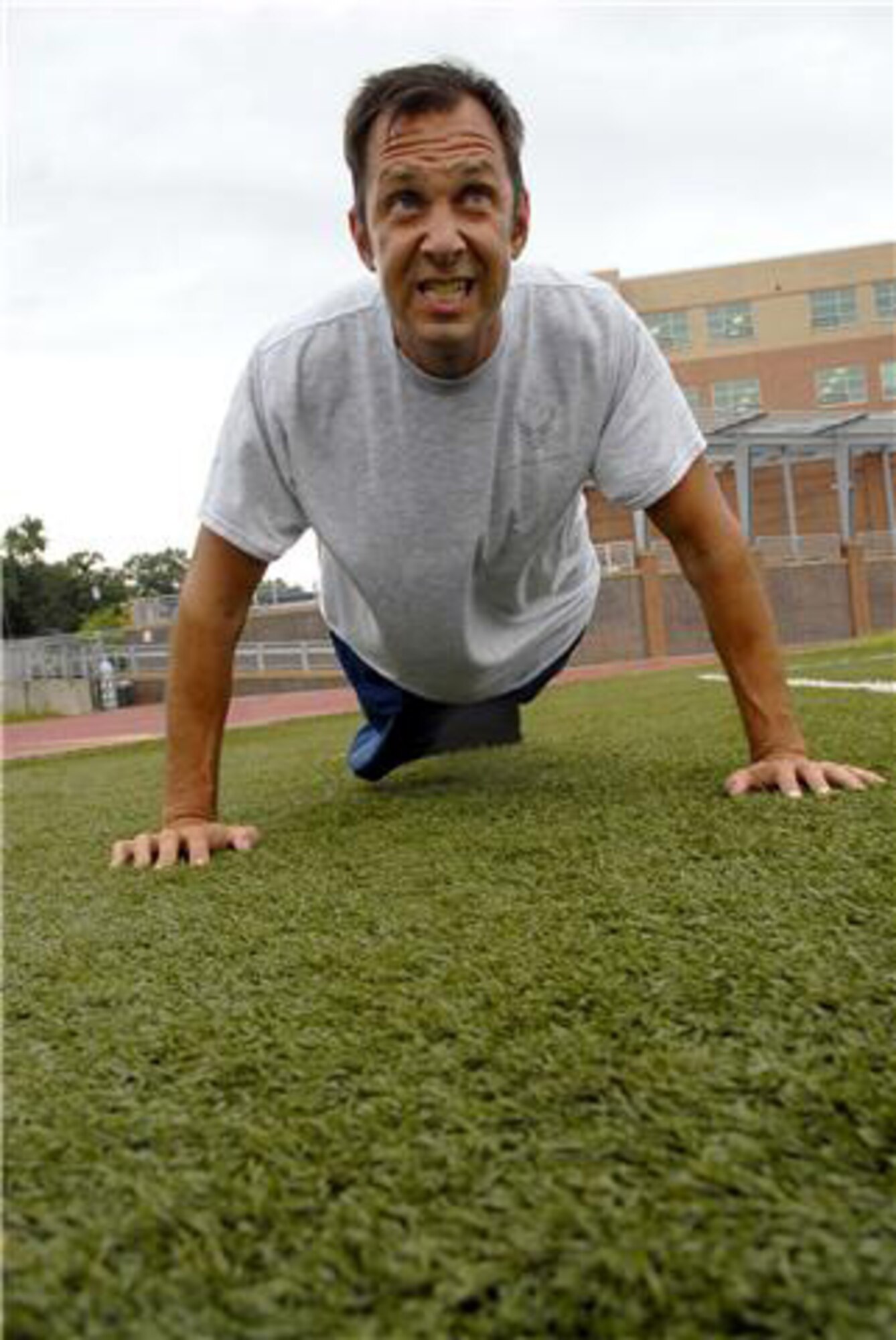 Senior Master Sgt. Kenneth Holcomb performs pushups for his fitness test, Sept. 8, 2009, in Washington, D.C. Although he needed to do 40 pushups to pass that portion of the test, Sergeant Holcomb did 50 and earned a perfect score. Sergeant Holcomb is the Air Force Public Affairs Agency media center superintendent. (U.S. Air Force photo/Tech. Sgt. Timothy O'Bryan) 