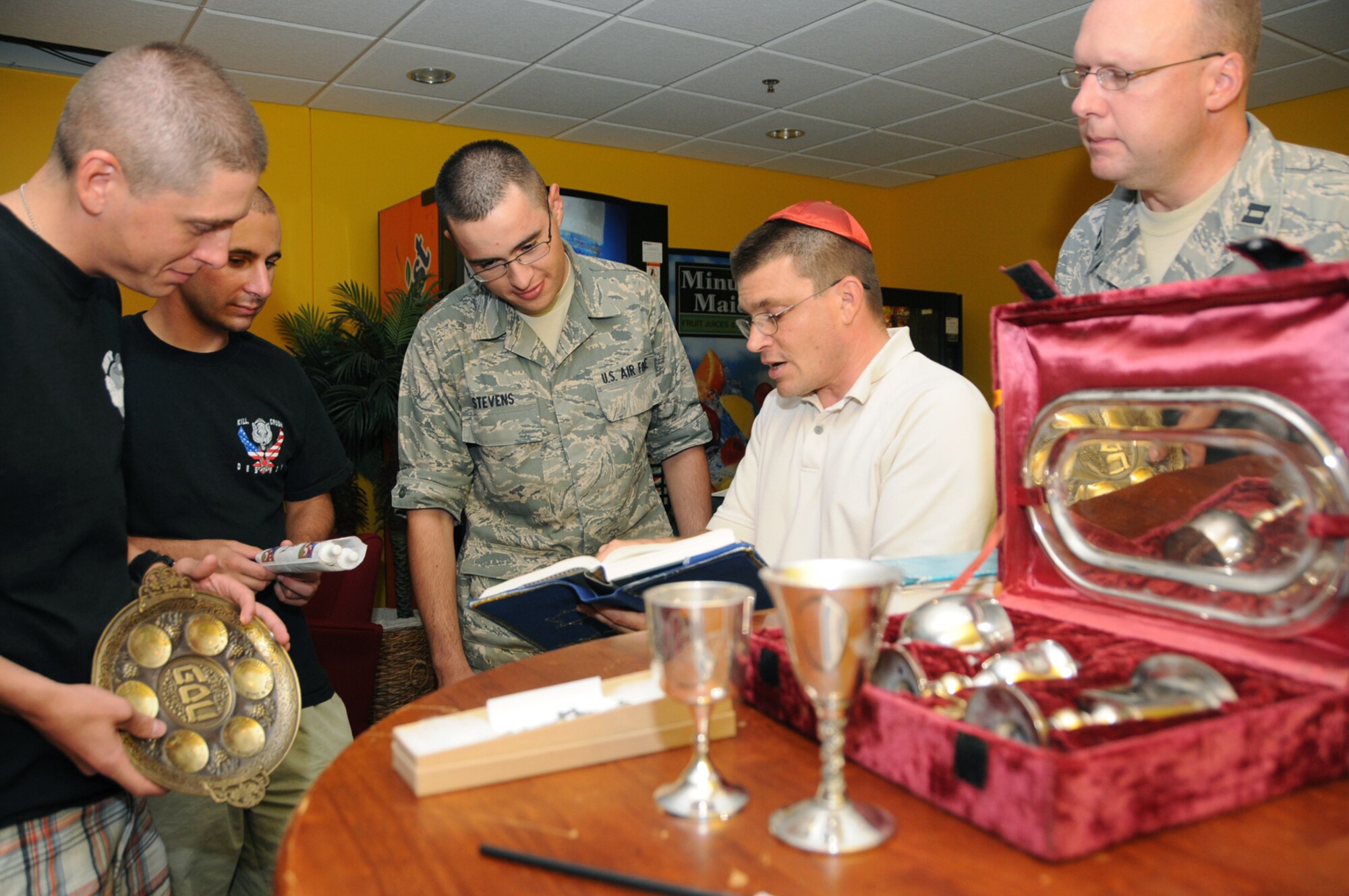 From left, Airmen 1st Class Jared Burrows and Matt Banach and Airman Basic Eric Stevens learn about items used in Jewish worship from Sergeant Raff as Chaplain Mallory looks on.  Airmen Burrows and Stevens are students in the 332nd Training Squadron and Airman Banach is from the 334th TRS.  (U.S. Air Force photo by Kemberly Groue)