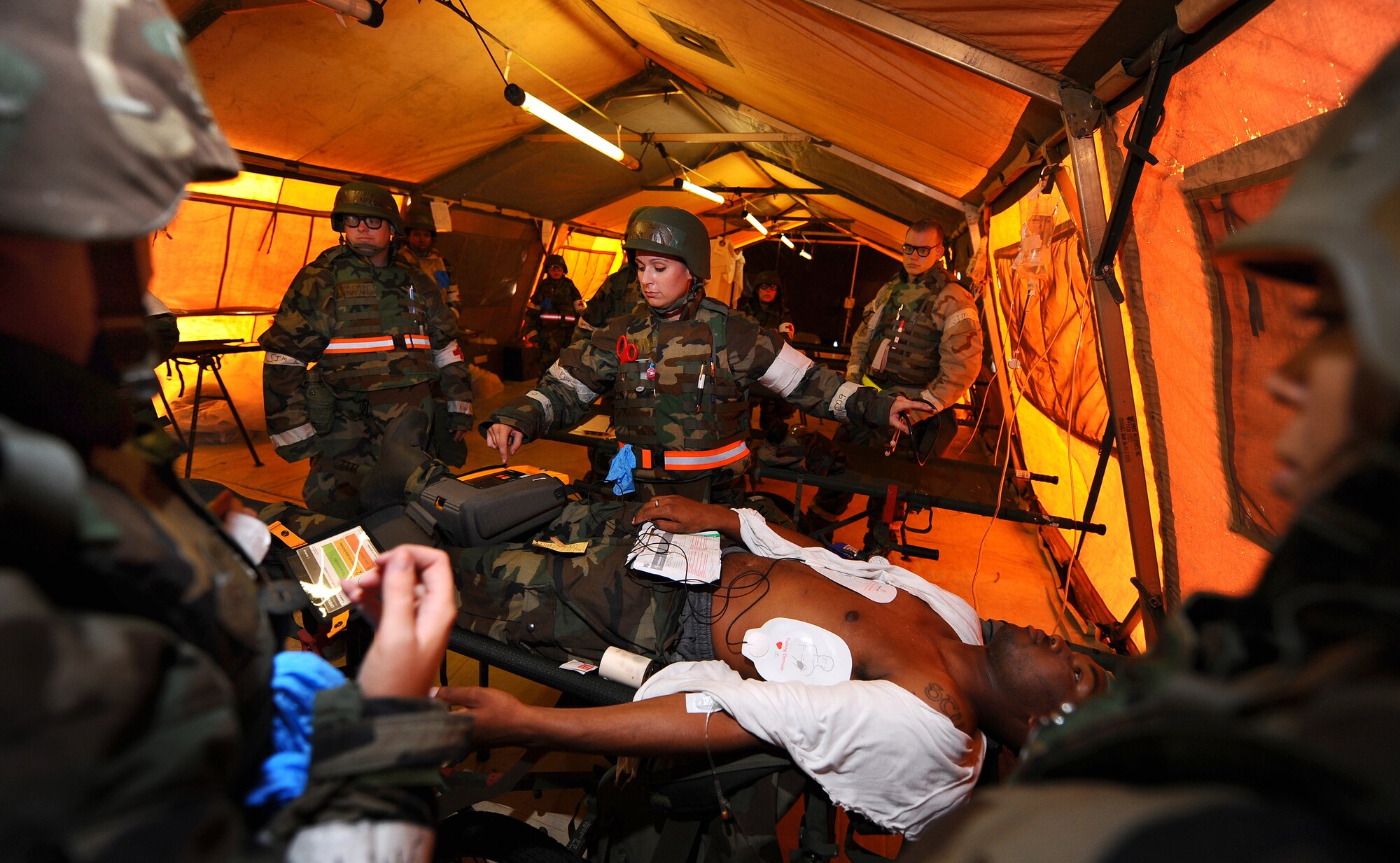 OFFUTT AIR FORCE BASE Neb. -- Staff Sgt. Rebekah Boe, 55th Medical Group, oversees the treatment of a mock patient requiring resuscitation inside the medical tent located at "Base X," Sept. 12, as part of an Operational Readiness Inspection here.  The 55th Wing earned an overall "Excellent" rating during the ORI. 

U.S. Air Force Photo by Josh Plueger
