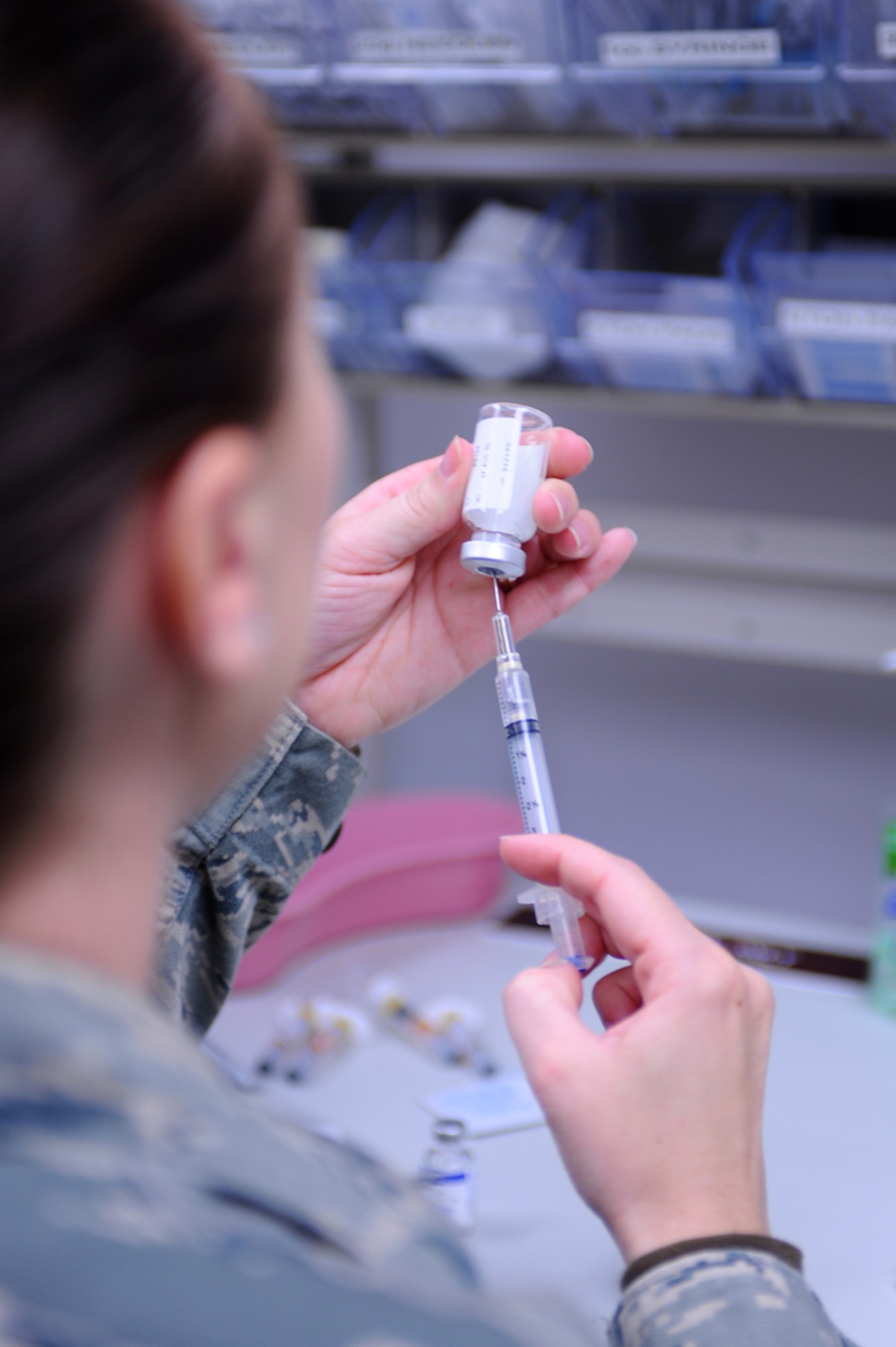 Senior Airman Megan Knutson, a medical technician assigned to the 28th Medical Operations Squadron at Ellsworth Air Force Base, S.D., fills a syringe for a vaccination May 13, 2009. (U.S. Air Force photo/Senior Airman Kasey Zickmund)