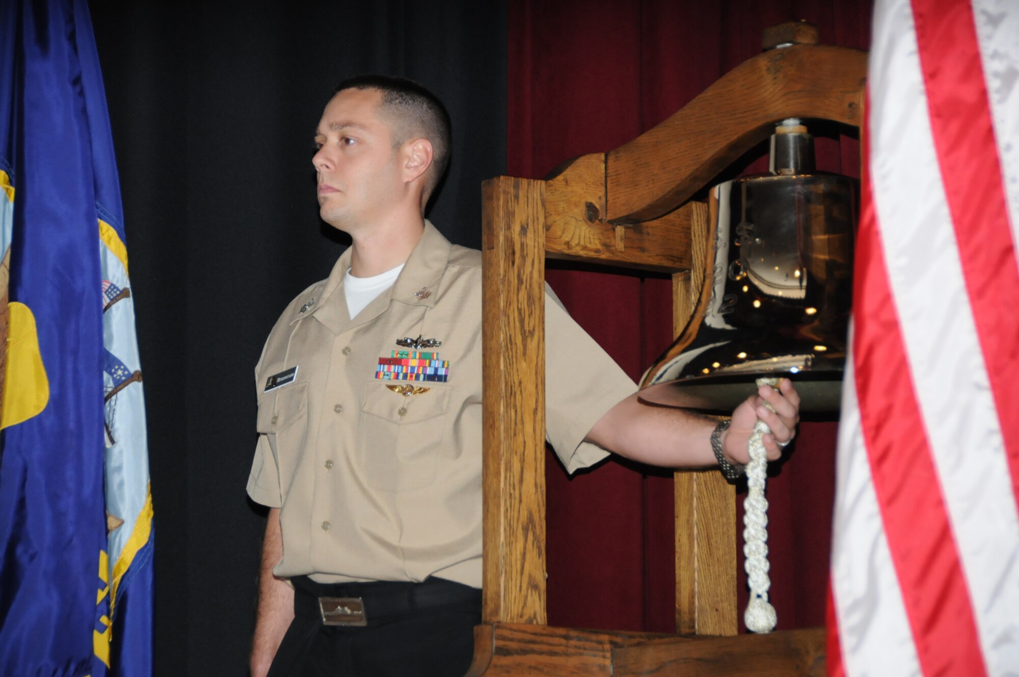 Aerographer’s Mate 1st Class Joshua Branscum tolls a bell in remembrance of those who died in the 9/11 attacks during a ceremony held at Welch Auditorium by Keesler’s Center for Naval Aviation Technical Training Unit.  (U.S. Air Force photo by Kemberly Groue)