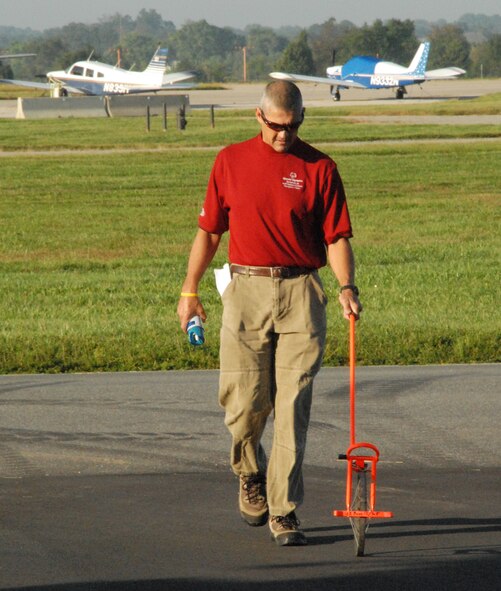 Mark Wise, Special Olympics director of sports training and volunteer management, measures out the route for a Special Olympics bicycle event being held on base at the Eagles Nest Picnic Area Sept. 18.  (U.S. Air Force photo/Staff Sgt. Chad Padgett)