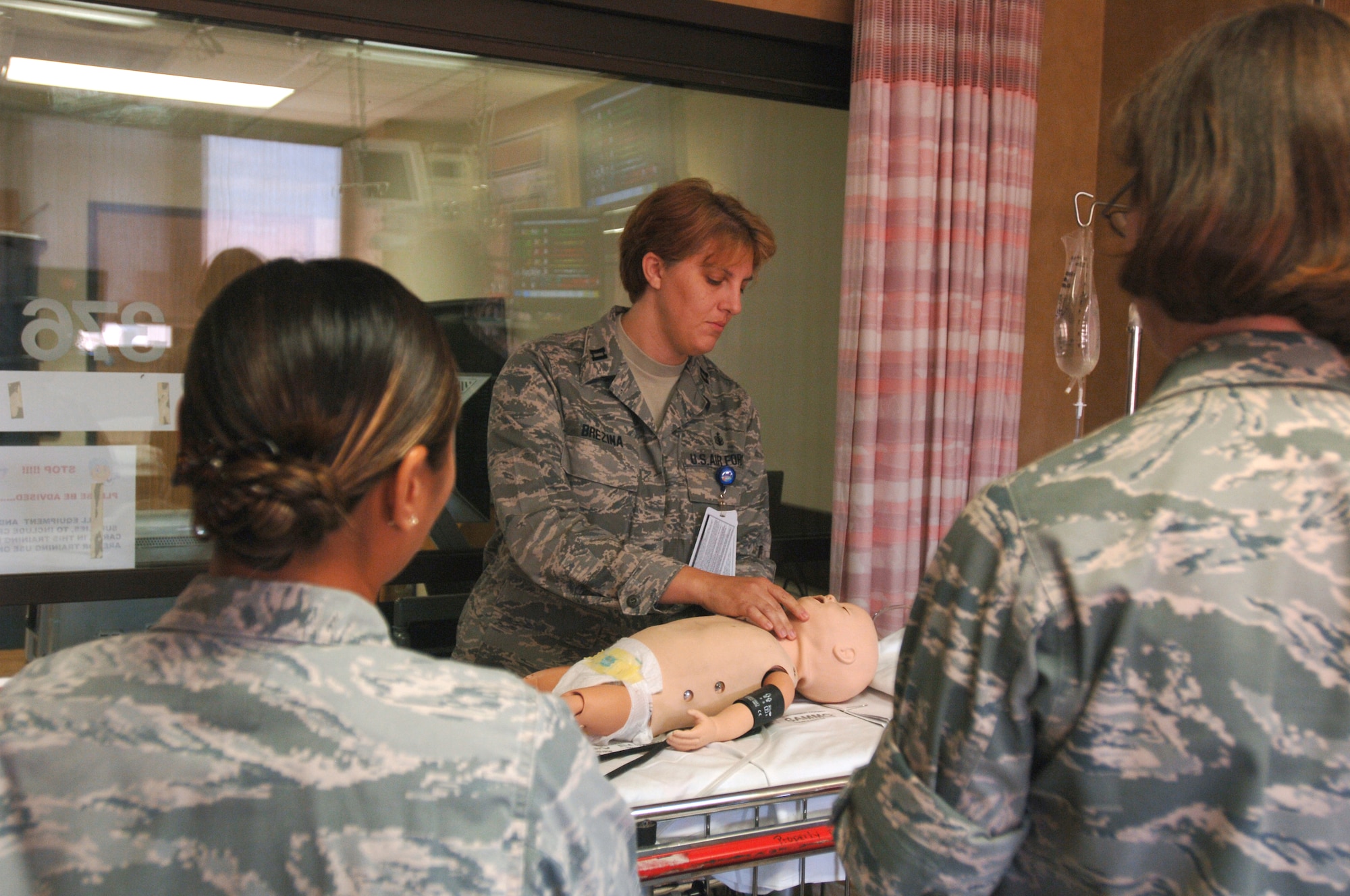 Capt. Laurie Brezina, clinical nurse, 59th Medical Inpatient Squadron, instructs nurses on how to check an infant's airway during the pediatric patient management portion of the readiness skills verification training on Sept. 9 at Wilford Hall Medical Center, Lackland Air Force Base, Texas.  The hands-on RSV training program is conducted quarterly at Wilford Hall to verify nurses are proficient in the basic to specialty-specific skills needed in patient care units in garrison and in the combat zone.  (U.S. Air Force photo by Senior Airman Nicole Roberts)     