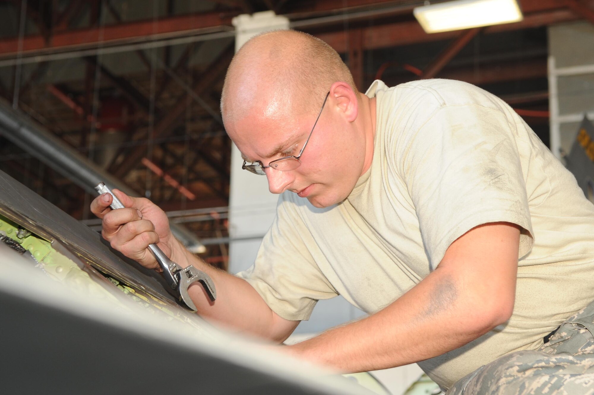 SHAW AIR FORCE BASE, S.C. -- Senior Airman Michael Kelly, 20th Aircraft Maintenance Squadron crew chief, removes a part from an F-16 as he prepares the jet for new modifications Sept. 9. The 20th AMXS and the depot field team from Hill Air Force Base, Utah, are installing the new modification to the F-16. The beyond-line-of-site satellit communication radios being installed allow the F-16 to utilize satellite communications to talk with units outside line-of-site. The end result is a greatly extended range of communication. (US Air Force Photo/Senior Airman David Minor) 