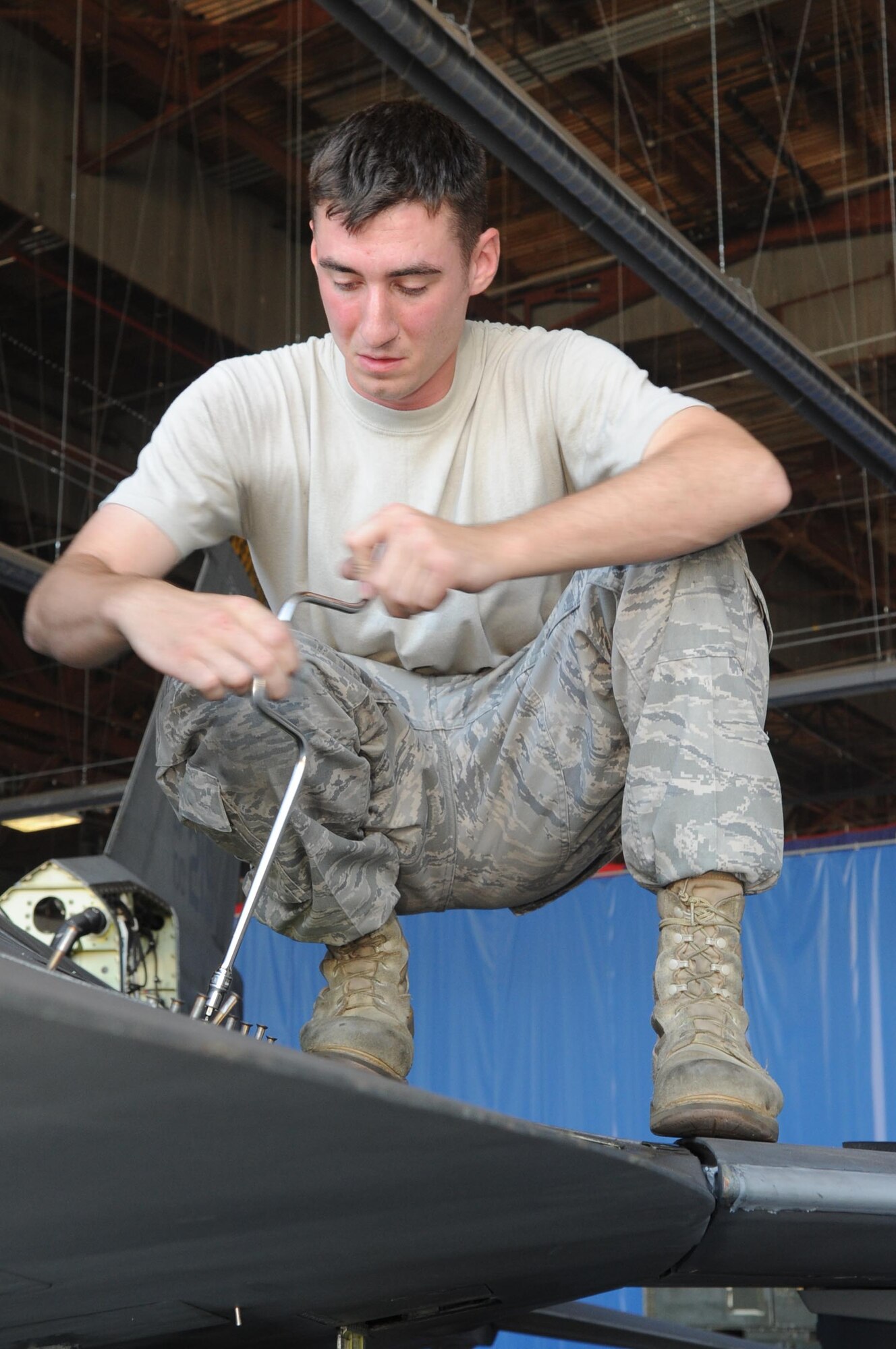 SHAW AIR FORCE BASE, S.C. -- Staff Sgt. Michael McMullen, 20th Aircraft Maintenance Squadron avionics specialist, removes a panel from an F-16 as he prepares the jet for new modifications Sept. 9. The 20th AMXS and the depot field team from Hill Air Force Base, Utah, are installing the new modification to the F-16. The beyond-line-of-sight satellite communication radios being installed allow the F-16 to utilize satellite communications to talk with units outside line-of-sight. The end result is a greatly extended communications range. (US Air Force Photo/Senior Airman David Minor)

