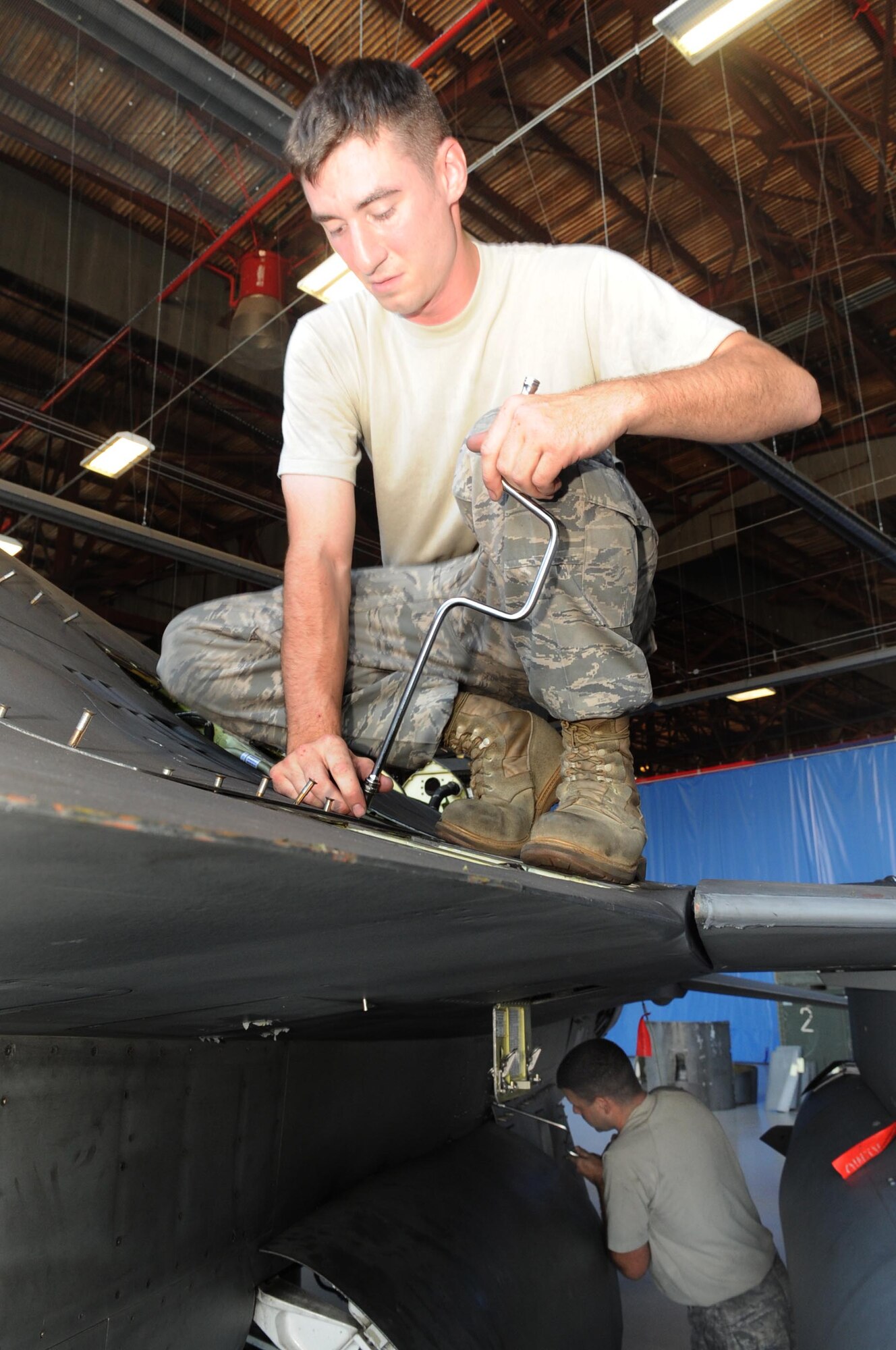 SHAW AIR FORCE BASE, S.C. -- Staff Sgt. Michael McMullen, 20th Aircraft Maintenance Squadron avionics specialist, removes a panel from an F-16 as he prepares the jet for new modifications Sept. 9. The 20th AMXS and the depot field team from Hill Air Force Base, Utah, are installing the new modification to the F-16. The beyond-line-of-sight satellite communication radios being installed allow the F-16 to utilize satellite communications to talk with units outside line-of-sight. The end result is a greatly extended communications range. (US Air Force Photo/Senior Airman David Minor) 


