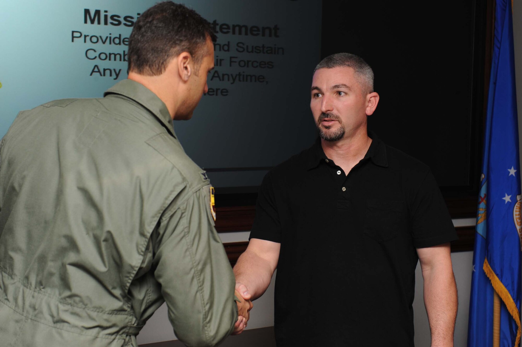 SHAW AIR FORCE BASE, S.C. -- Jerry Kimsey, depot field team lead from Hill Air Force Base, Utah, receives a 20th Fighter Wing coin from Col. Joseph Guastella, 20th FW commander, for his efforts in the 79th Fighter Squadron's F-16 modifications Sept. 16. One of the modifications made by Mr. Kimsey's team and 20th FW maintainers was simplifying the F-16 canopy removal process, saving one maintenance day. (U.S. Air Force photo/ Senior Airman Matt Davis)
