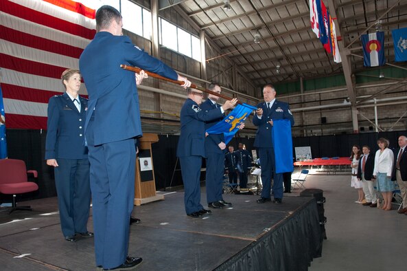 HANSCOM AIR FORCE BASE, Mass. - Col. Dana S. Marsh, 622nd Regional Support Group commander, from Dobbins Air Reserve Base, Ga., left, stands by as Staff Sgt. Richard Leger, of the 85th Aerial Port Squadron, holds the squadron’s guidon for other members of the 85 APS -- Senior Master Sgt. Joseph Barszcz, the oldest member of the squadron; Senior Airman Matthew Diperri, the youngest member; and Tech. Sgt. Richard Chartienitz, the Airman with the longest time in the unit at 29 years -- to furl it, symbolizing the squadron’s de-activation after nearly 50 years of service. The ceremony took place in the Aero Club Hangar Sept. 13. (U. S. Air Force photo by Rick Berry)