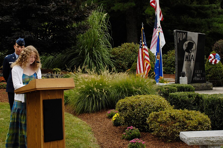 HANSCOM AIR FORCE BASE, Mass. - Kathryn Murdock, a student at Hanscom Middle School and the winner of the Sept. 11 essay contest, reads her essay to the crowd consisting of commanders, honorary commanders, civic leaders, law enforcement, fire, medical professionals and other Hanscom community members, during Hanscom’s remembrance of the eighth anniversary of Sept. 11, 2001, at the POW/MIA Memorial park on the corner of Barksdale and Grenier Streets. (U.S. Air Force photo by Linda LaBonte Britt)