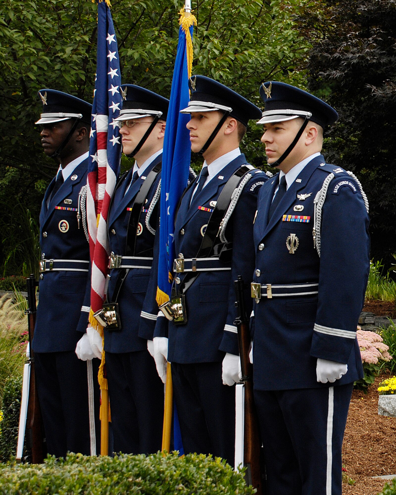 HANSCOM AIR FORCE BASE, Mass. - From left, Senior Airman Albert Lewis, 1st Lt. Christopher Rose, 1st Lt. Marshal Conover and Capt. Michael Crowl, participate in Hanscom’s eighth anniversary remembrance of the Sept. 11, 2001, terrorist attacks. The Patriot Honor Guard raised the flags to half-staff, in honor of Patriot Day, a national observance held every year on Sept. 11 honoring those that died as a result of the attacks. (U.S. Air Force photo by Linda LaBonte Britt)