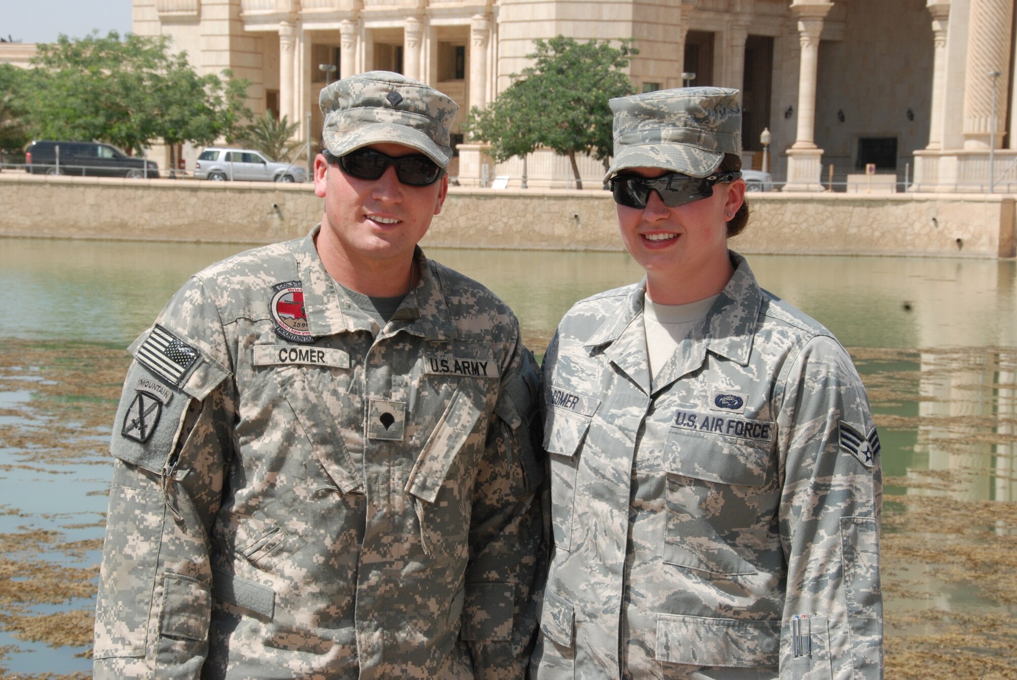 Army Spc. Jeffrey Comer and his sister, Air Force Senior Airman Jessica Comer pose near a lake at the Al Faw Palace in Baghdad. The Comer family enjoys a proud history of military service