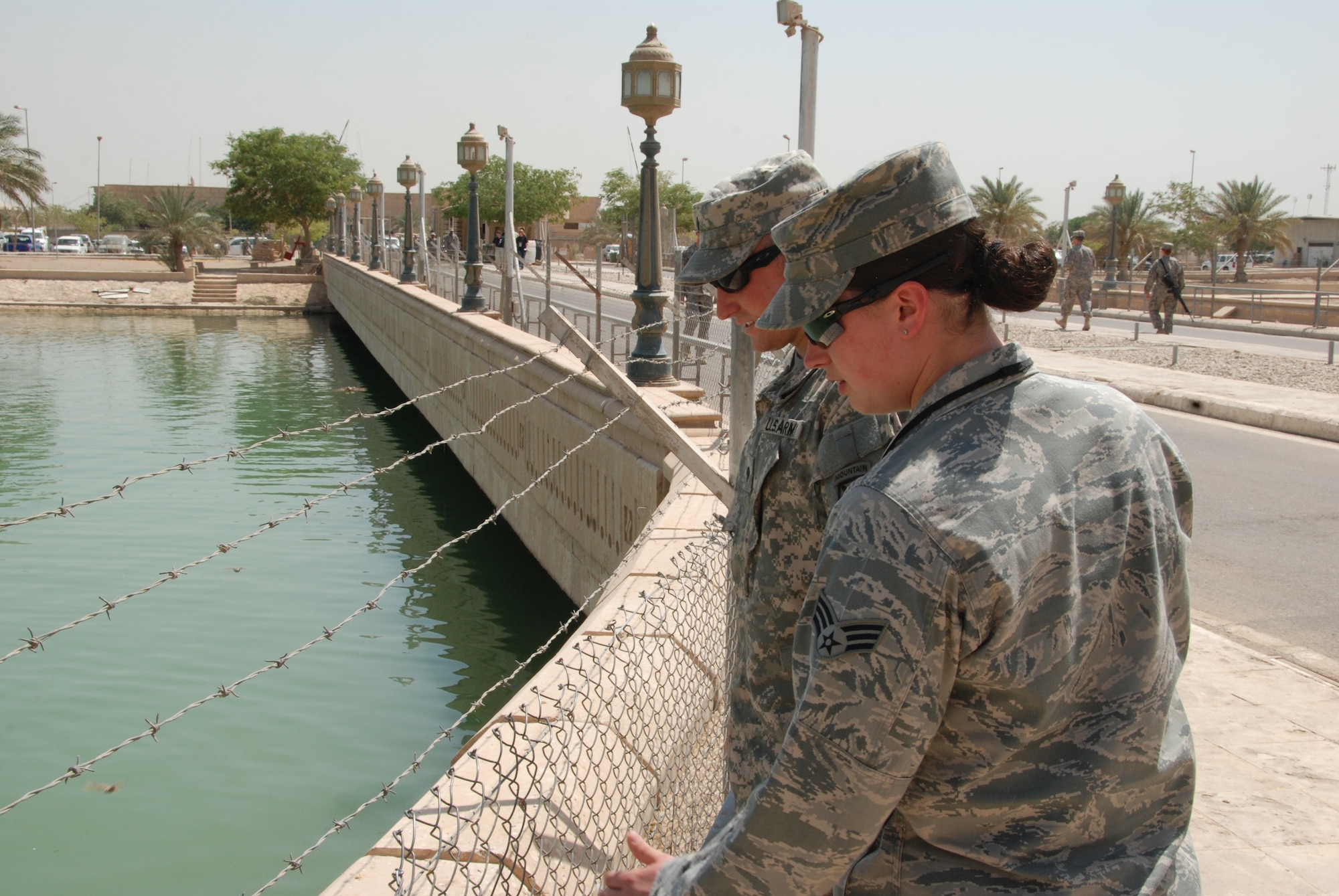 Army Spc. Jeffrey Comer and his sister, Air Force Senior Airman Jessica Comer, view a lake at the Al Faw Palace in Baghdad.  The brother-sister pair spent time together in Baghdad visiting historic landmarks while on a four-day pass. 