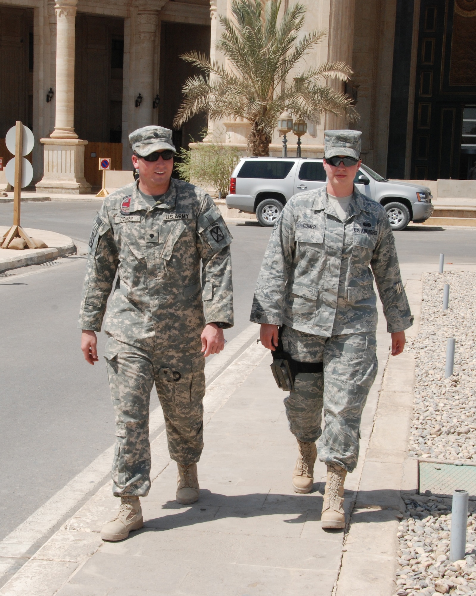 Army Spc. Jeffrey Comer and his sister, Air Force Senior Airman Jessica Comer, go for a stroll at the Al Faw Palace in Baghdad. The brother and sister are both serving tours of duty in Iraq. 