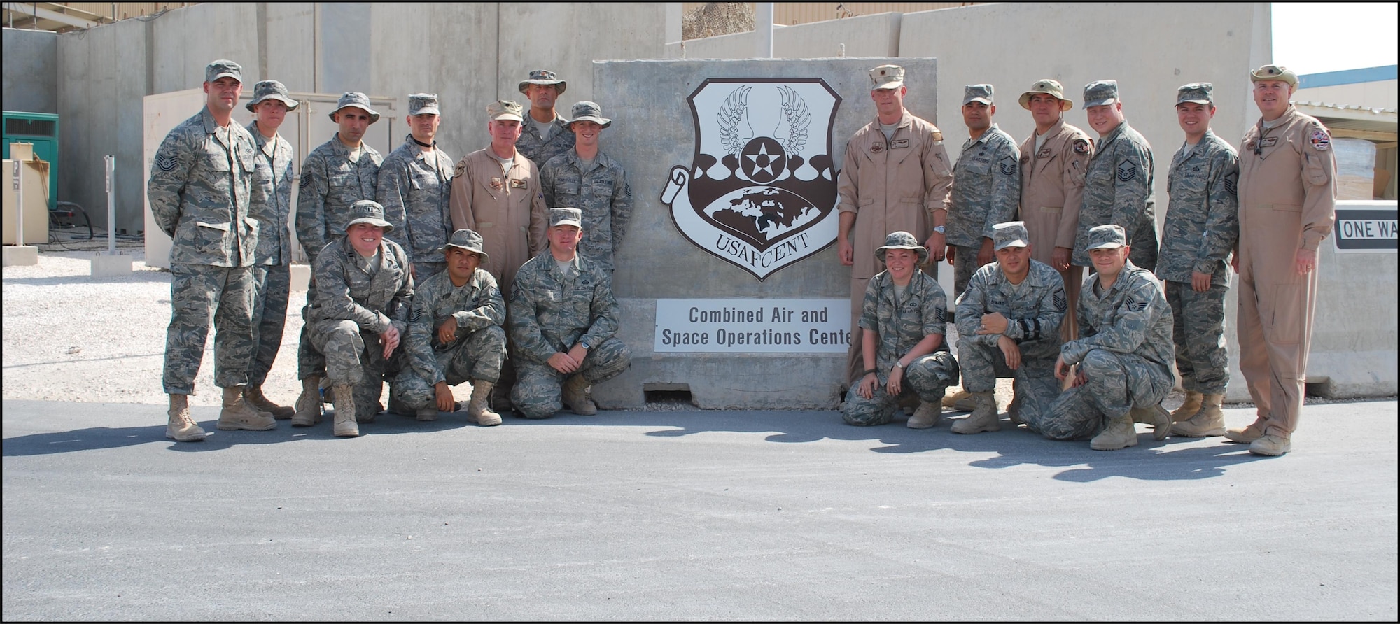 Maj. Robert O'Connor, 2nd Lt. Chad Montague, Master Sgt. Dan Hughes and Staff Sgt. Tim D'Amico of the 103rd Air intelligence Squadron and Master Sgt. Ben Abbot and Master Sgt. Pete Demakis of the 103rd Air Operations Squadron stand with their team members from the 710th Combat Operations Squadron and the 609th Air Operations Center Detachment 1 in front of the Combined Air Operations Center, Southwest Asia, early September 2009.  The team was tasked to field test command and control capabilities there.  (photo courtesy of 2nd Lt. Chad Montague)