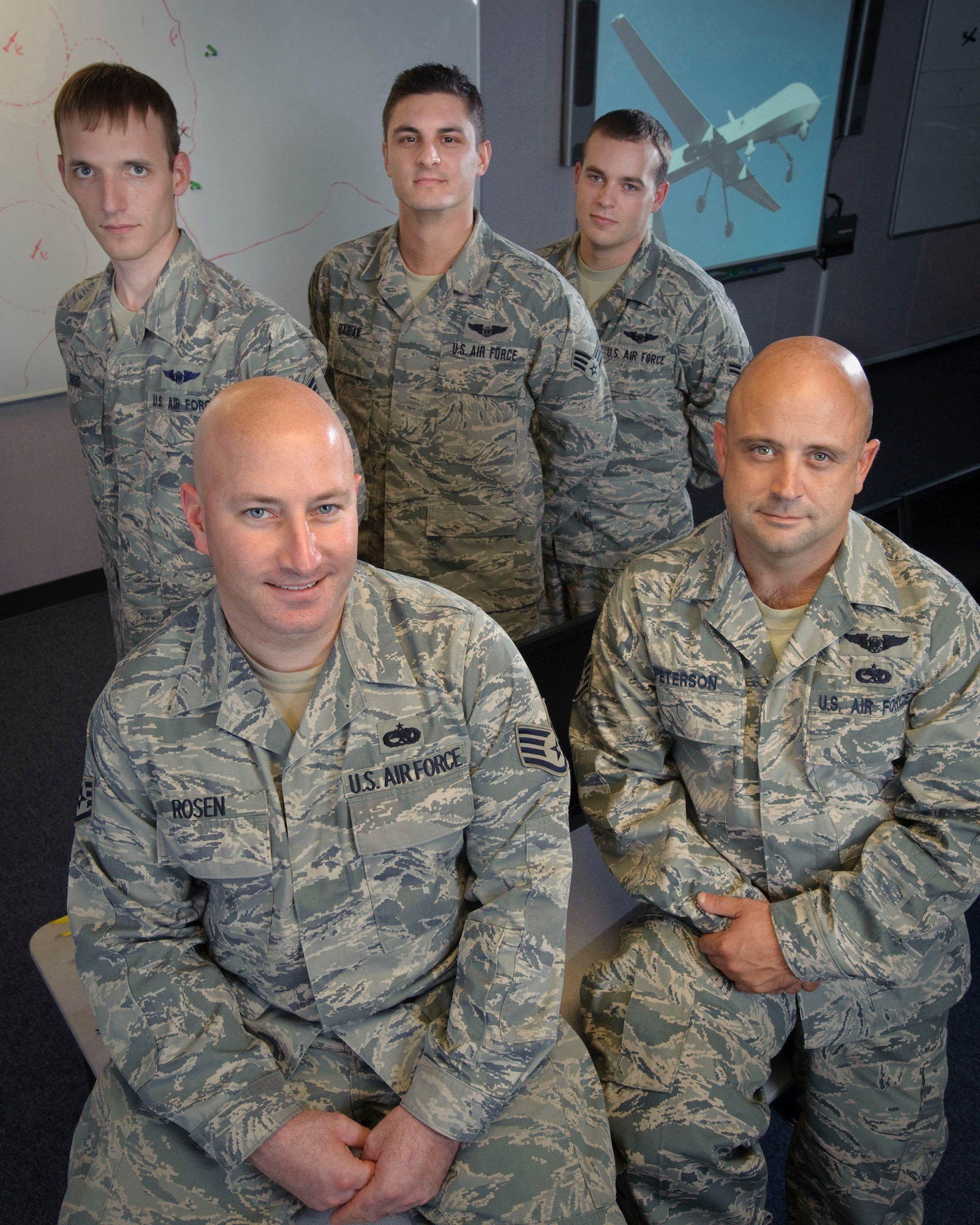 (Front row) Staff Sgt. Adam Rosen, Staff Sgt. Jason Peterson, (back row) Staff Sgt. Jeremy Reid, Senior Airman Robert Babian, and Airman 1st Class Ronald Shortledge are the graduates of the inaugural Basic Sensor Operator Course taught at Randolph Air Force Base, Texas, to prepare enlisted members for careers as Unmanned Aerial Systems Sensor Operators. (U.S. Air Force photo/Steve Thurow)