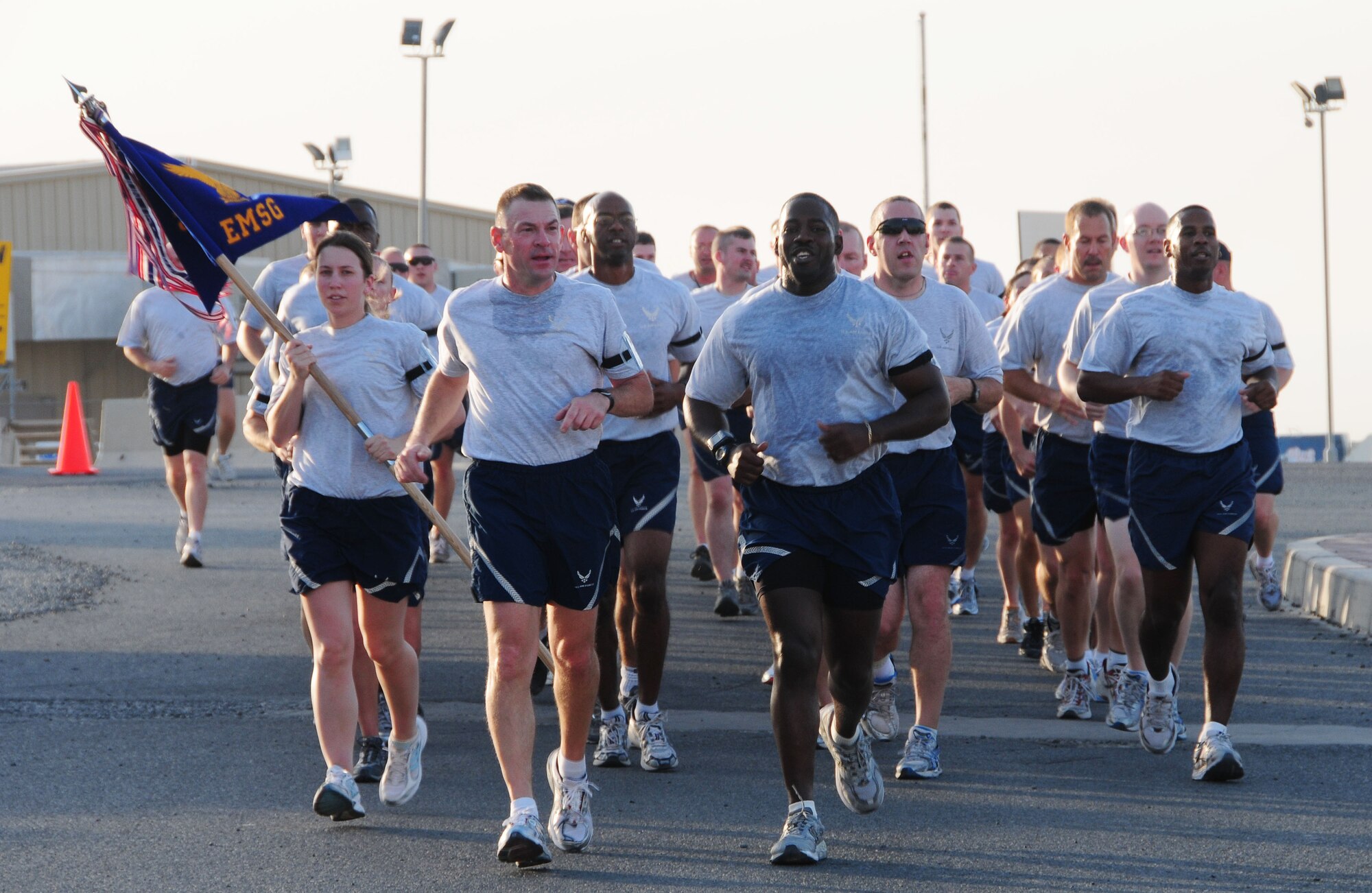 SOUTWEST ASIA -- Col. Richard McComb, 386th Expeditionary Mission Support Group commander, left, and Chief Master Sgt. Marcus Snoddy, 386th EMSG superintendant, lead 386th EMSG members in a 9-11 memorial run. The group ran in formation for 55 consecutive minutes, to pay tribute to the 55 military members who lost their lives in the attacks that day. (U.S. Air Force photo/Tech. Sgt. Tony Tolley)