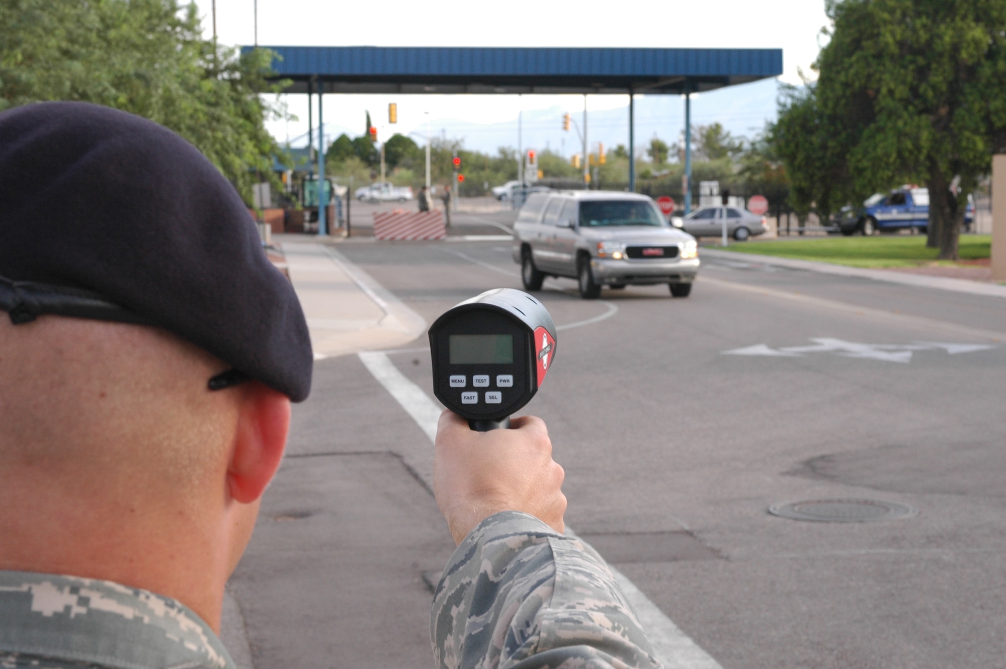 Senior Airman Darrel Stone, 162nd Security Forces Squadron, tests a new hand-held radar on base Sept. 12. Radar guns will be used to deter speeding thereby enhancing safety on base. (Air National Guard photo by Staff. Sgt. Jordan Jones)