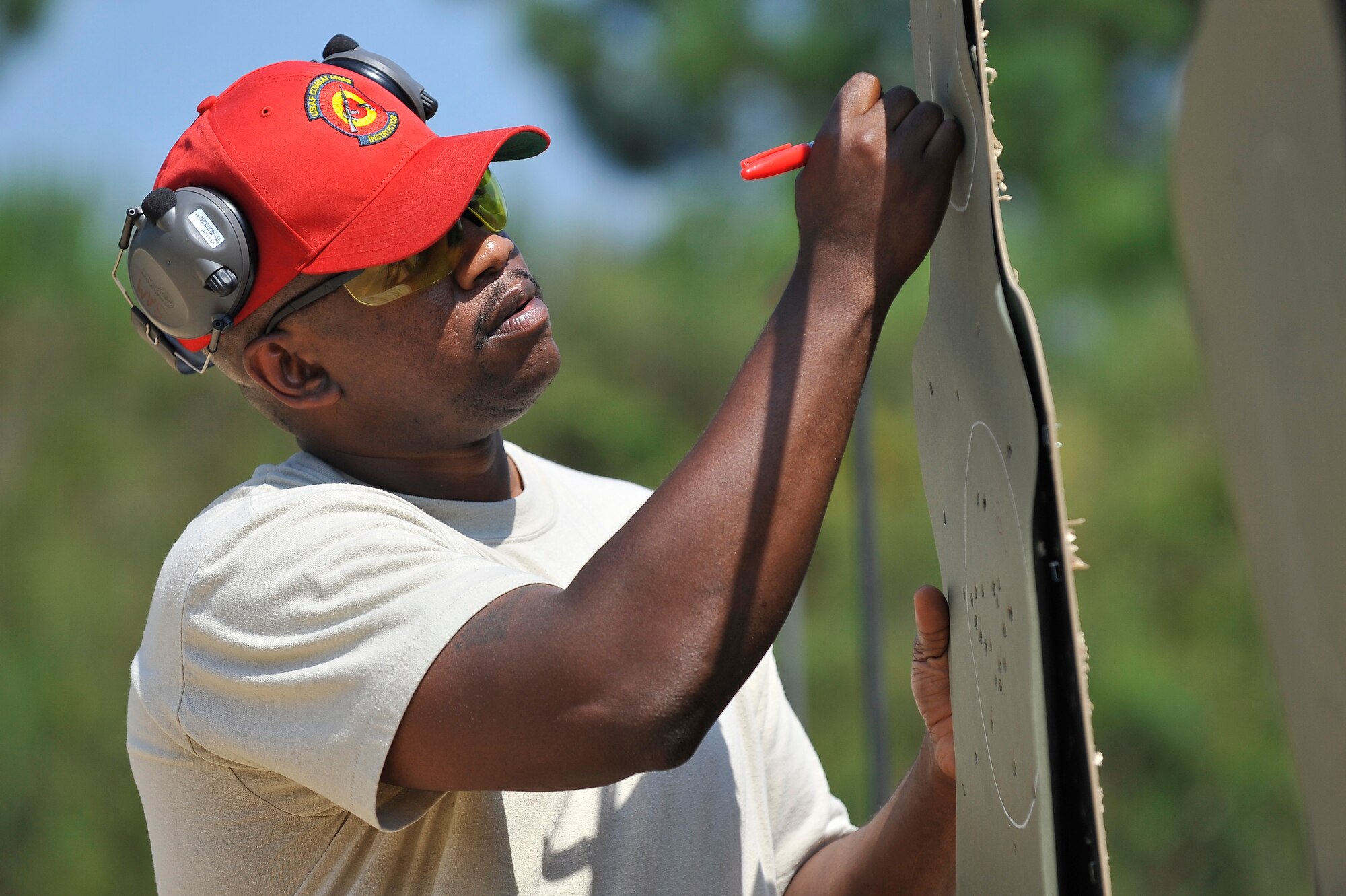 Staff Sgt. Errol Samuel scores an M-16 target after students qualified on the firing range at Naval Weapons Station Charleston, S.C., Sept. 10. Students are provided classroom instruction at Charleston AFB followed by an afternoon of training and qualification firing at the Naval station's range. Sergeant Samuel is a combat arms instructor with the 437th Security Forces Squadron. (U.S. Air Force photo/ James M. Bowman)