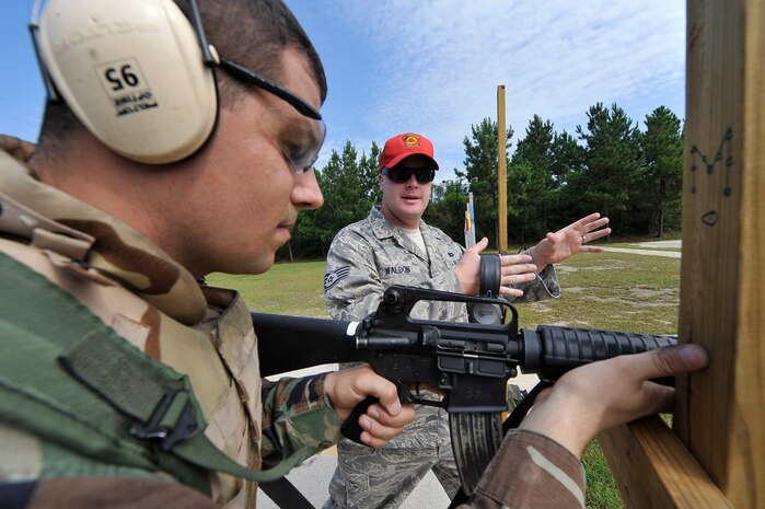Staff Sgt. Anthony Waldon gives over-barricade position instructions to Tech. Sgt. Joe Varney during a M-16 qualification course at Naval Weapons Station Charleston, S.C., Sept. 10. Instructors teach students techniques such as controlled breathing and trigger pull to keep their shots on target. Sergeant Varney is a contract specialist with the 437th Contracting Squadron and Sergeant Waldon is a combat arms instructor with the 437th Security Forces Squadron. (U.S. Air Force photo/ James M. Bowman)