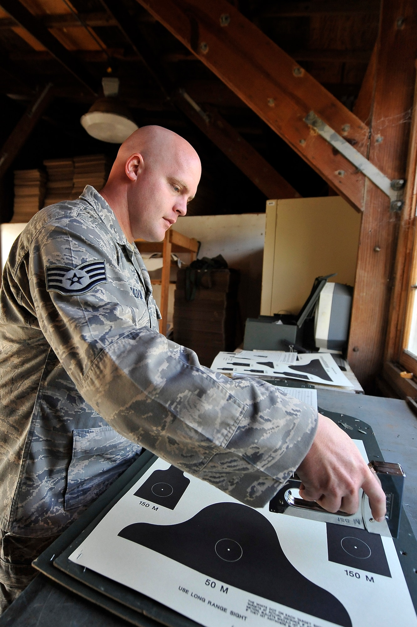 Staff Sgt. Anthony Waldon prepares targets for students attempting to qualify on the M-16A2 rifle at the Naval Weapons Station Charleston, S.C., firing range Sept. 10. The 437th Security Forces Squadron combat arms instructors utilize the range to train students from Charleston AFB. Sergeant Waldon is a combat arms instructor with the 437 SFS. (U.S. Air Force photo/ James M. Bowman)

