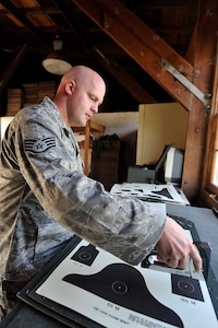 Staff Sgt. Anthony Waldon prepares targets for students attempting to qualify on the M-16A2 rifle at the Naval Weapons Station Charleston, S.C., firing range Sept. 10. The 437th Security Forces Squadron combat arms instructors utilize the range to train students from Charleston AFB. Sergeant Waldon is a combat arms instructor with the 437 SFS. (U.S. Air Force photo/ James M. Bowman)
