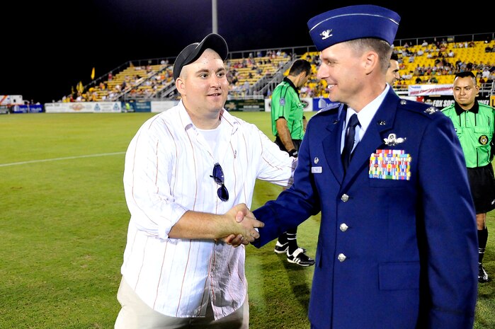 Shaun Robey shakes hands with Col. John Wood after the coin toss during the Charleston Battery soccer team's military appreciation night held at Blackbaud Stadium on Daniel Island Sept. 11. "Thank You Heroes" was the name of the soccer event played by the Charleston Battery versus the Miami F.C. Blue to honor veterans, fire fighters, police officers and paramedics. Mr. Robey is a disabled Army veteran who returned served in Operation Iraqi Freedom, and Colonel Wood is the 437th Airlift Wing commander. (U.S. Air Force photo/James M. Bowman)
