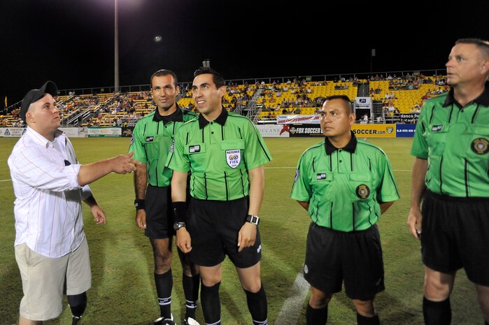 Shaun Robey tosses the coin while referees look on during the Charleston Battery soccer team's military appreciation night held at Blackbaud Stadium on Daniel Island Sept. 11. The soccer team provided free tickets for members of Team Charleston to attend the game. Mr. Robey is a disabled Army veteran who returned served in Operation Iraqi Freedom. (U.S. Air Force photo/James M. Bowman)