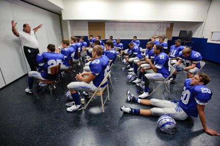 Ro-Hawks defensive coordinator Phil Karrer goes over strategy with varsity players before the Ro-Hawks first home game Friday September 11, 2009. (U.S. Air Force photo/Steve Thurow)