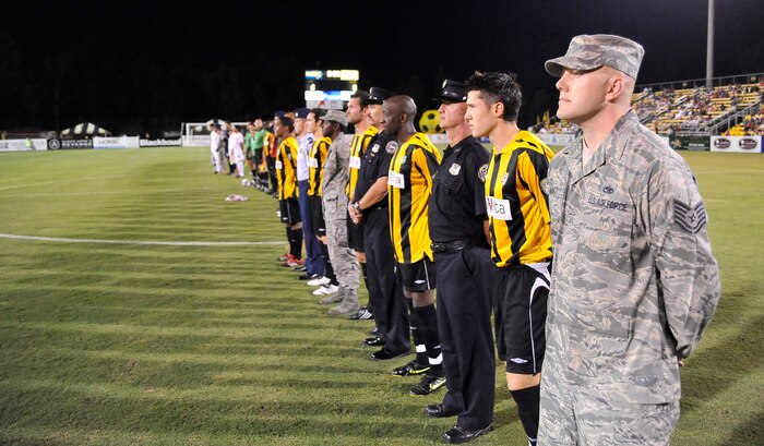 Tech. Sgt. Alexander Arntz participates in  pre-game ceremonies during the Charleston Battery soccer team's military appreciation night held at Blackbaud Stadium on Daniel Island Sept. 11. Team members were escorted to the field by active-duty members, Reservists, veterans, police officers, firefighters and paramedics before the start of the game as part of the night's event. Sergeant Arntz is an aircraft guidance systems craftsman with the 315th Aircraft Maintenance Squadron.(U.S. Air Force photo/James M. Bowman)