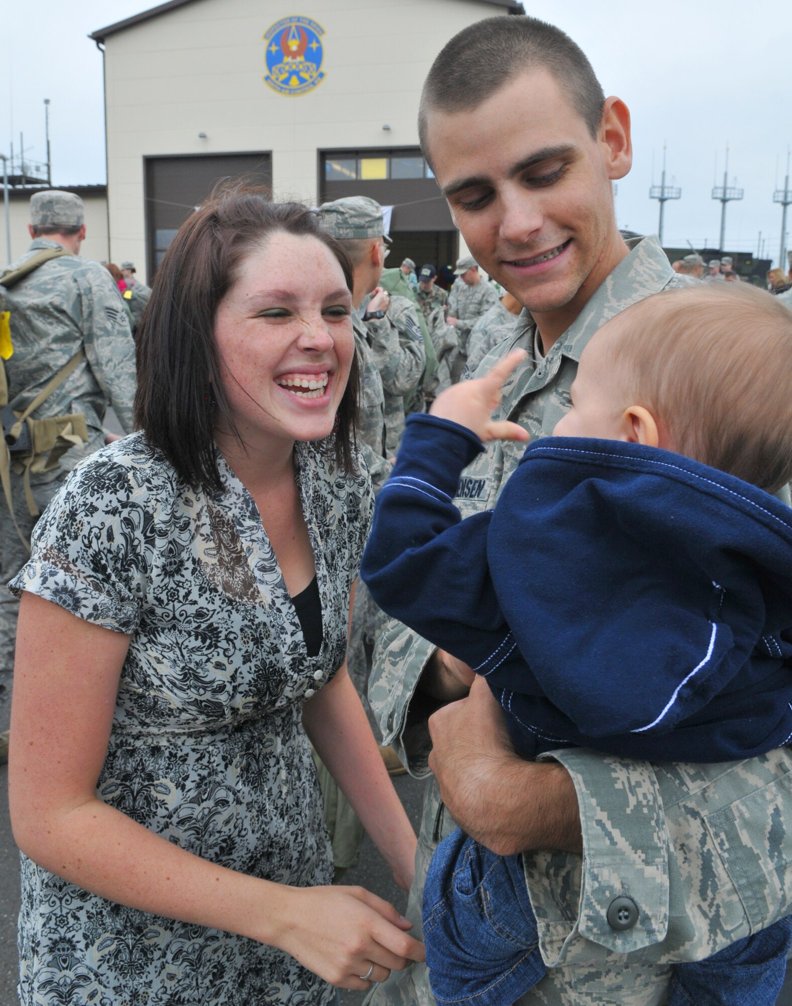 SPANGDAHLEM AIR BASE, Germany – Airman 1st Class Devin Christensen, 606th Air Control Squadron hugs his son Maxten while his wife Robyn looks on after returning from a four-month deployment to Kandahar, Afghanistan, Sept. 16.  About 60 members of the 606th ACS operated radar and communication for command and control for the 71st Expeditionary Air Control Squadron as well as to support air battle management. The unit also deployed 300 short tons of equipment to support air battle management operations and more than 13,000 sorties.  Approximately 30 other 606th ACS members also returned from a four-month deployment to southwest Asia in support of the 73rd EACS.  (U.S. Air Force photo/Airman 1st Class Nick Wilson)