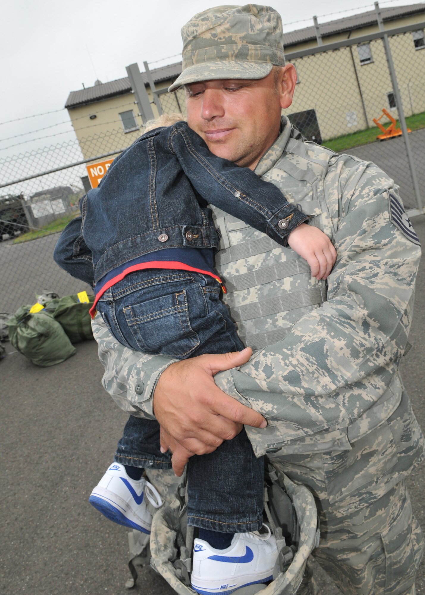 SPANGDAHLEM AIR BASE, Germany – Tech. Sgt. Thomas Crutchfield, 606th Air Control Squadron, hugs his son Landon after returning from a four-month deployment to Kandahar, Afghanistan, Sept. 16.  About 60 members of the 606th ACS operated radar and communication for command and control for the 71st Expeditionary Air Control Squadron.  The unit also deployed 300 short tons of equipment to support air battle management operations and more than 13,000 sorties.  Approximately 30 other 606th ACS members also returned from a four-month deployment to southwest Asia in support of the 73rd EACS.  (U.S. Air Force photo/Airman 1st Class Nick Wilson)