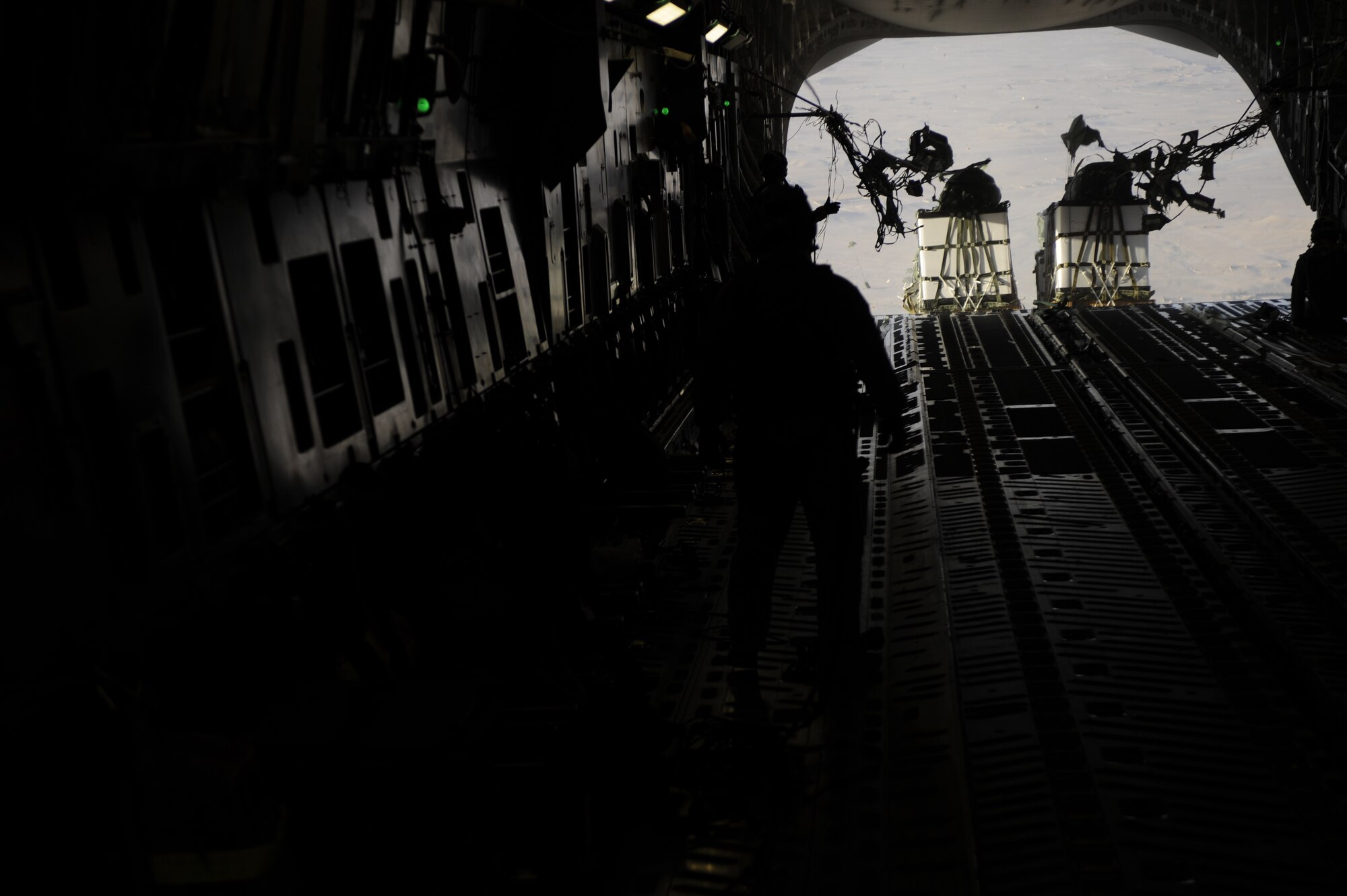 U.S. Air Force loadmasters assigned to the 816th Expeditionary Airlift Squadron conduct an air drop from a C-17 Globemaster III aircraft over the southern region of Afghanistan on Sept. 2, 2009. Pallets are being air-dropped to provide needed supplies to ground personnel. (U.S. Air Force Photo/Staff Sgt. Shawn Weismiller)