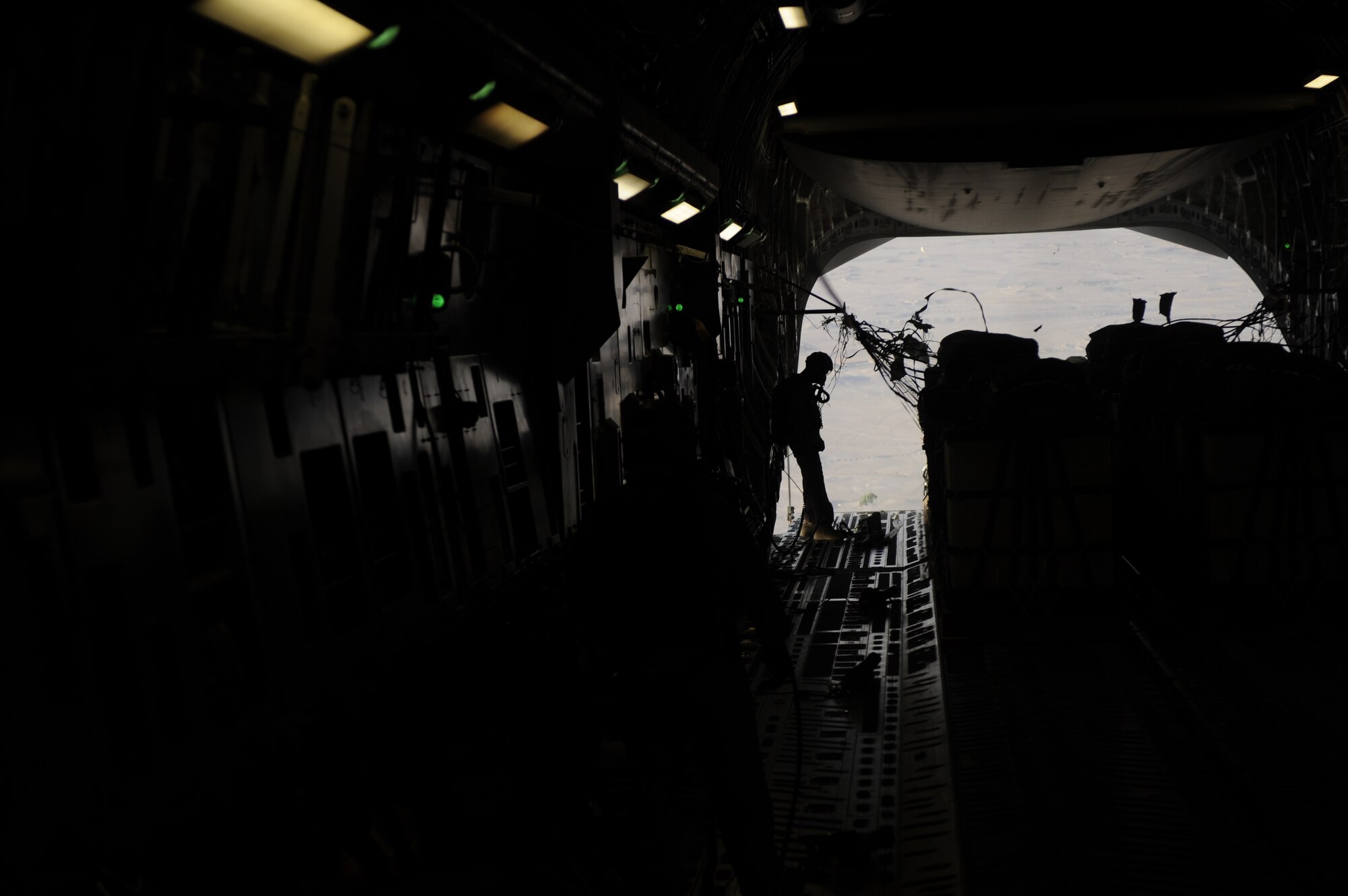 A U.S. Air Force loadmaster assigned to the 816th Expeditionary Airlift Squadron monitors pallets as they are airdropped from a C-17 Globemaster III aircraft over the southern region of Afghanistan on Sept. 2, 2009. Pallets are being airdropped to provide needed supplies to ground personnel. (U.S. Air Force Photo/Staff Sgt. Shawn Weismiller)