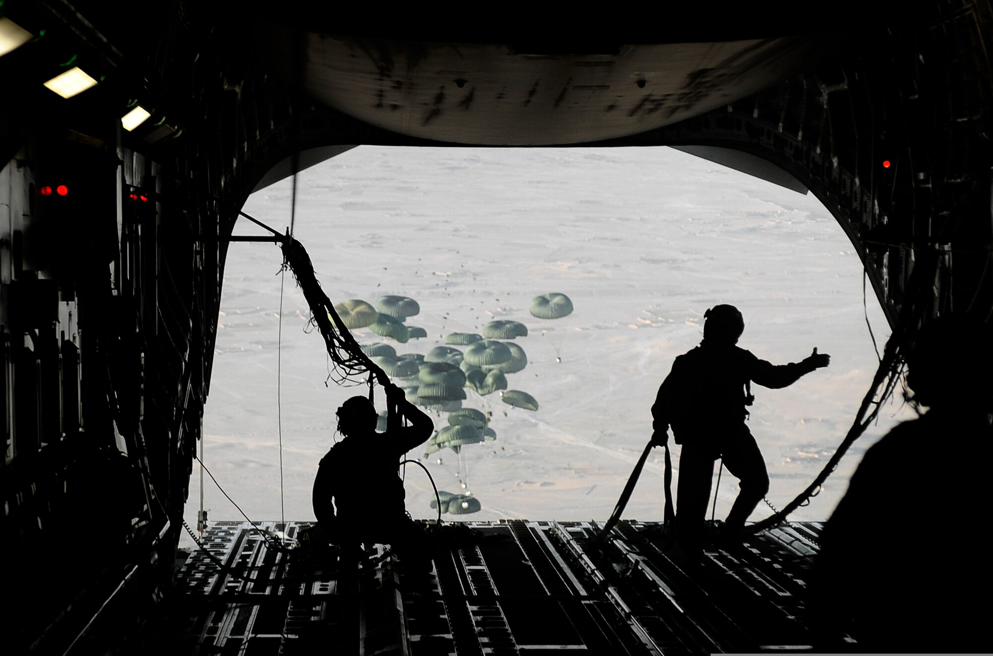 U.S. Air Force loadmasters assigned to the 816th Expeditionary Airlift Squadron conduct an airdrop from a C-17 Globemaster III aircraft over the southern region of Afghanistan on Sept. 2, 2009.  Pallets are being air-dropped to provide needed supplies to ground personnel.  (U.S. Air Force Photo/Staff Sgt. Shawn Weismiller)