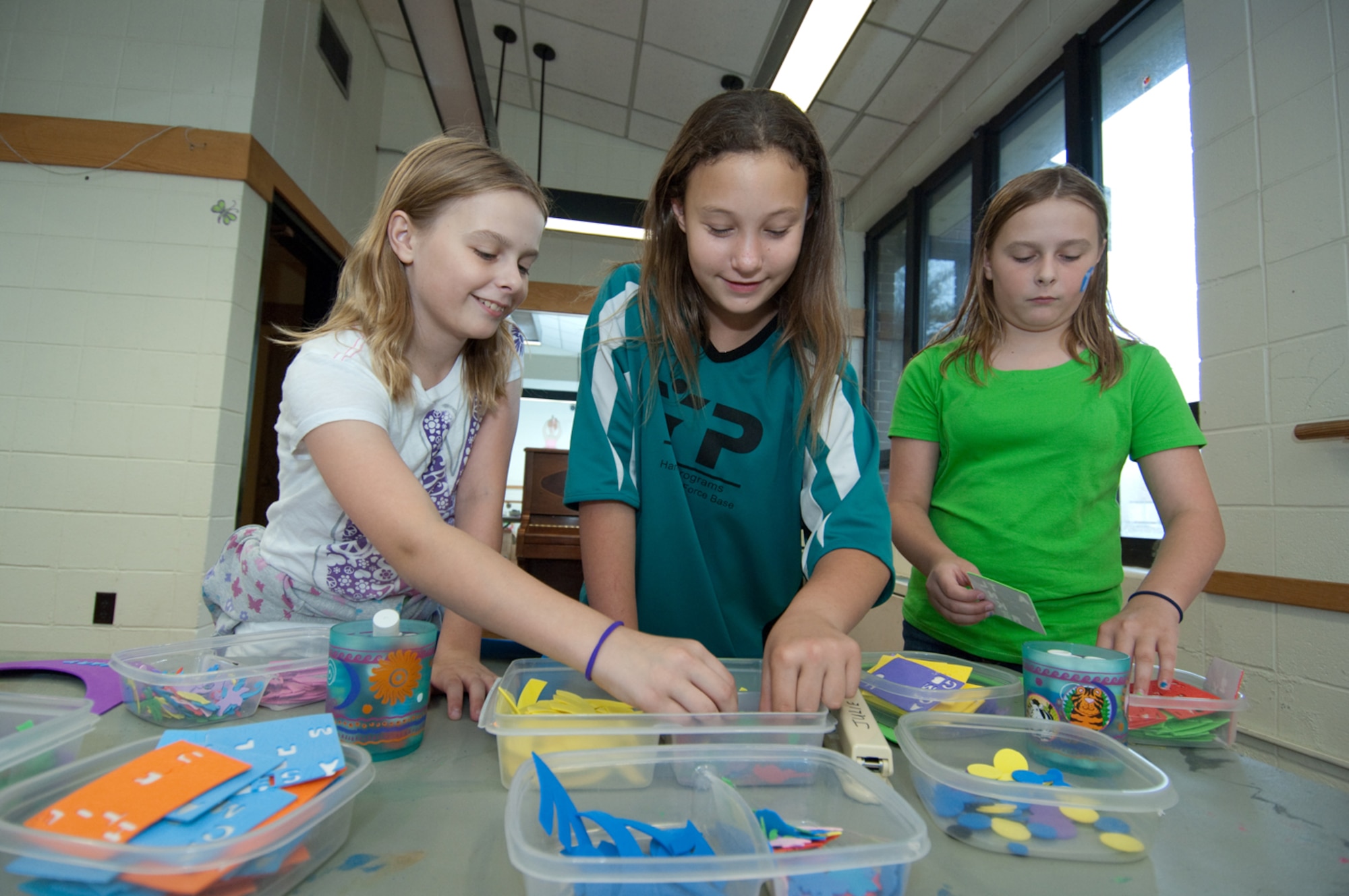 HANSCOM AIR FORCE BASE, Mass. – The 66th Force Support Squadron hosted its annual Boys & Girls Club Day for Kids on Sept. 12 at the Youth Center. Pictured (left to right), Elizabeth Koehler, Courtney Martin and Mary Koehler make a craft at one of the activity tables. The event included games, activities and food. For more information on Youth Center activities call 781-377-3739 or go online to www.hanscomservices.com. (U.S. Air Force photo by Rick Berry)