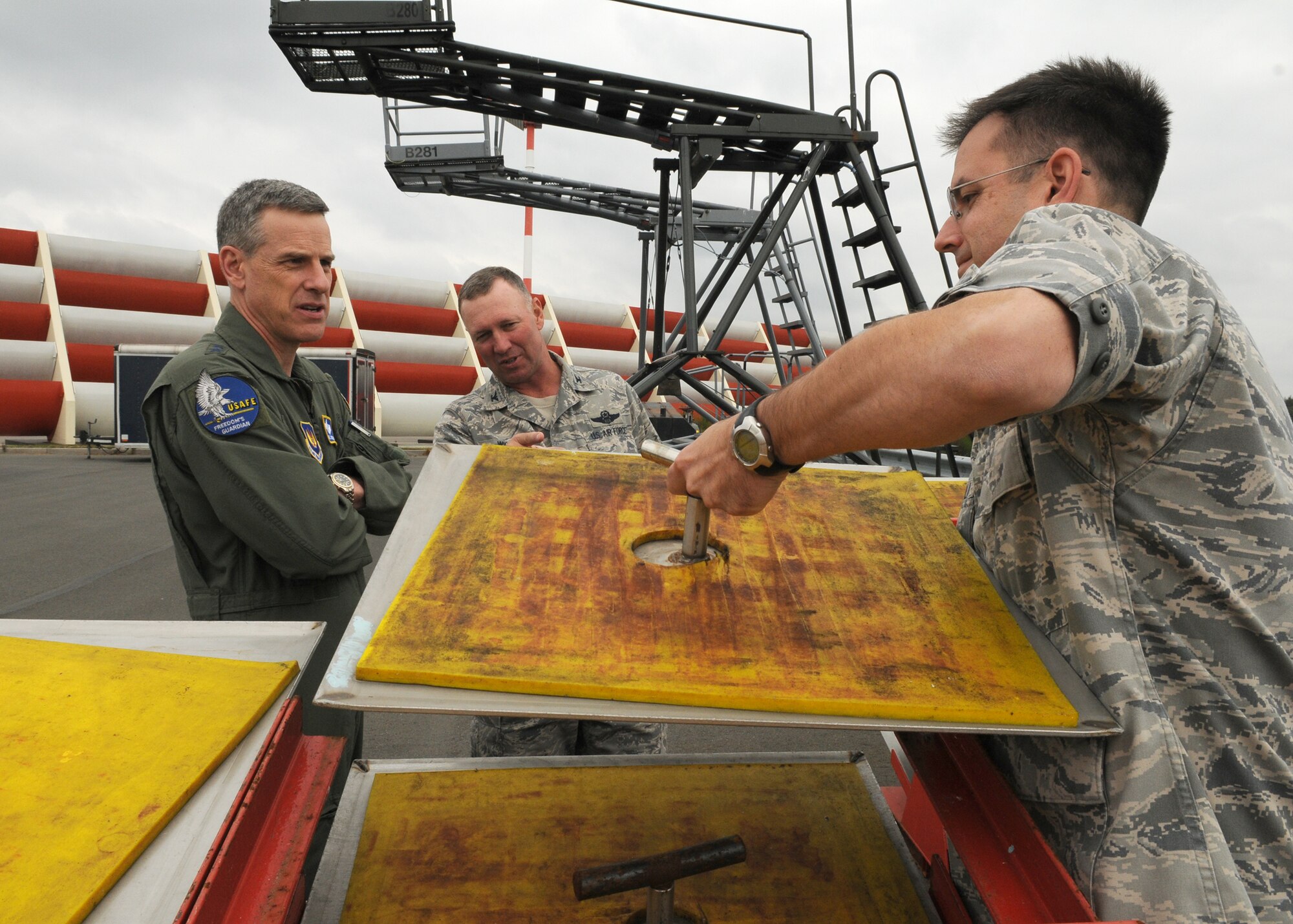 SPANGDAHLEM AIR BASE, Germany -- Col. Tip Wight, 52nd Fighter Wing commander, and Lt. Col. Dennis Primoli, 726th Air Mobility Squadron commander, explain to Maj. Gen. William Chambers, U.S. Air Forces in Europe vice commander, the process the 52nd FW uses to prevent de-icer from entering the environment and local water supply Sept. 15. General Chambers was here for an orientation after assuming his new position. (U.S. Air Force photo/Airman 1st Class Nathanael Callon)