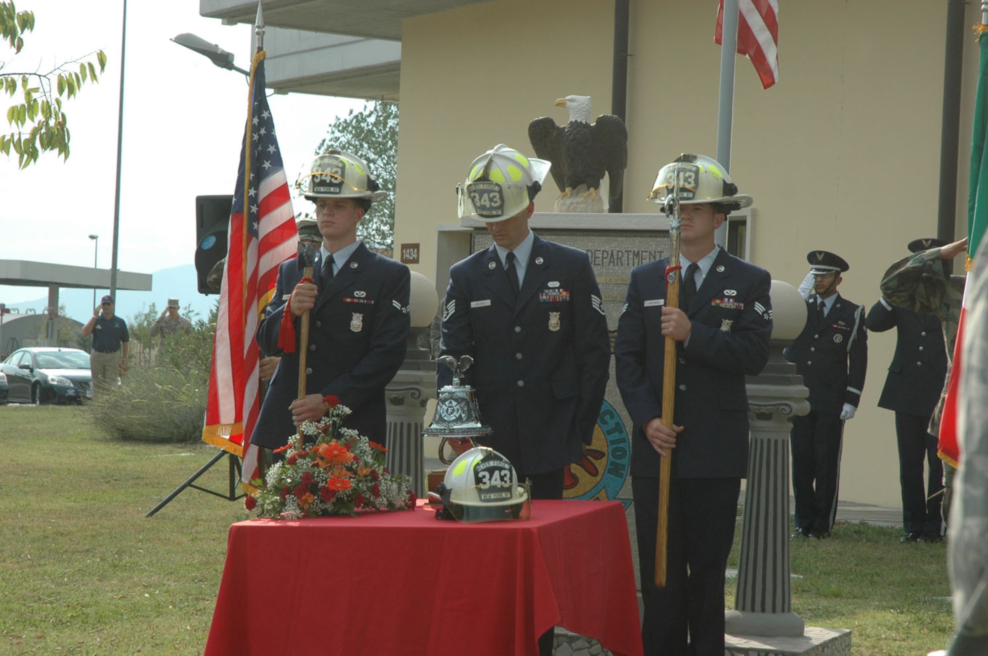 Firefighters assigned to the 31st Civil Engineer Squadron fire department ring the fire bell three times during a Sept. 11, 2009 remembrance ceremony at Aviano Air Base, Italy.  The ringing of the fire bell is in honor of those fallen firefighters who died during the terrorist attacks on Sept. 11, 2001.  The ceremony took place in front of the base fire department.  (U.S. Air Force photo/Staff Sgt. Mercedes Crossland)