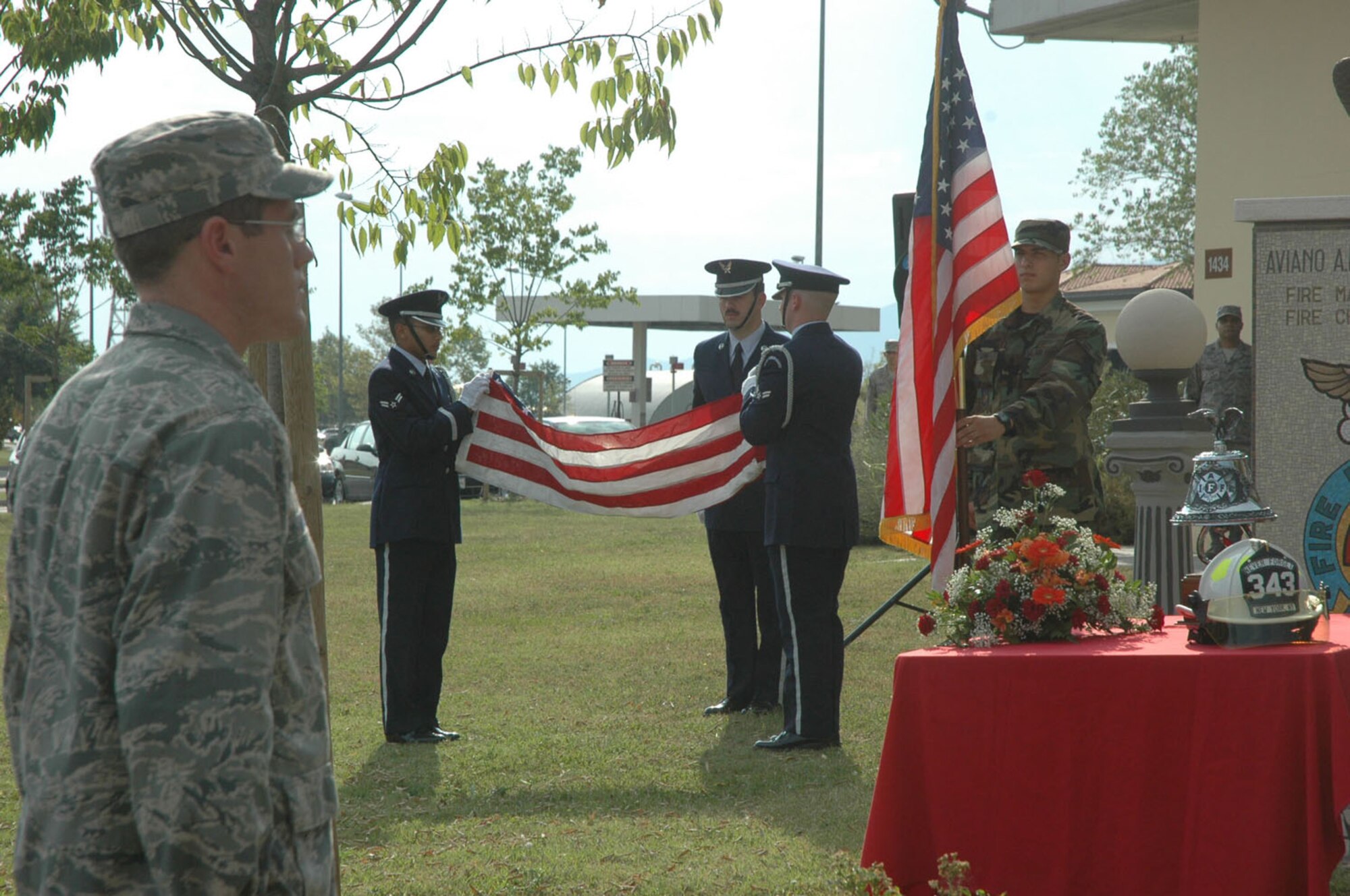 A base honor guard detail assigned to the 31st Fighter Wing fold the U.S. flag during a remembrance ceremony Sept. 11, 2009 at Aviano Air Base, Italy.  The ceremony took place in front of the base fire department and has been held annually since the tragic events of Sept. 11, 2001 occurred in New York, Pennsylvania and at the Pentagon. (U.S. Air Force photo/Staff Sgt. Mercedes Crossland)