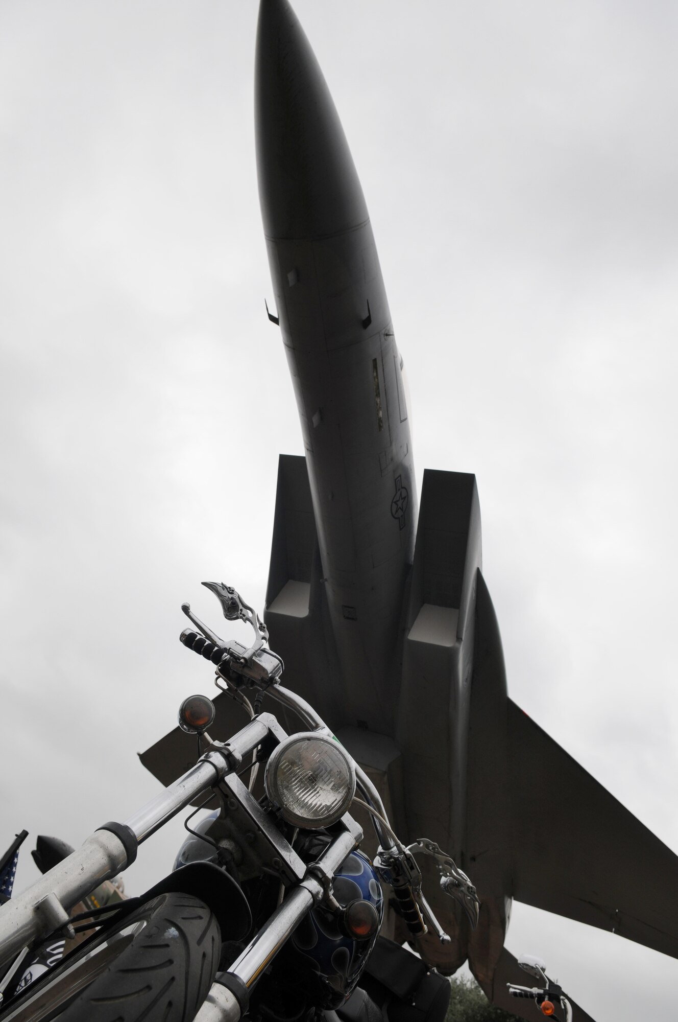 RAF MILDENHALL, England -- One of more than 50 motorcycles of the "Rolling Thunder" memorial ride sits under a static aircraft at RAF Lakenheath's Memorial Park by the 'Lest we Forget' wall Sept. 15. Riders stopped at American and British war memorials, two each, to lay wreaths and have a moment of silence during Prisoner of War/Missing in Action remembrance week. (U.S. Air Force photo/Senior Airman Thomas Trower)