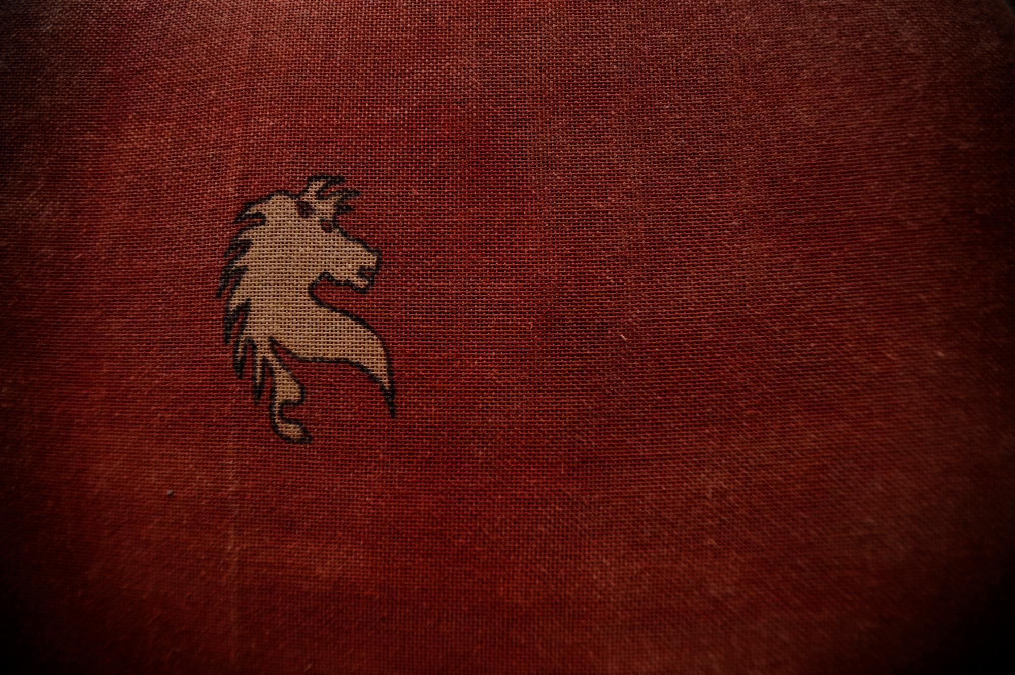 The symbol of the historic U.S. Air Force Red Horse unit was painted on a handmade preecher curl bench in the gym at Forward Operating Base Dwyer where Airman from the 809th Expeditionary Red Horse Squadron, 1st Expeditionary Red Horse Group have been working on construction and airfield projects Sept. 10. (U.S. Air Force Photo/Staff Sgt. Shawn Weismiller)