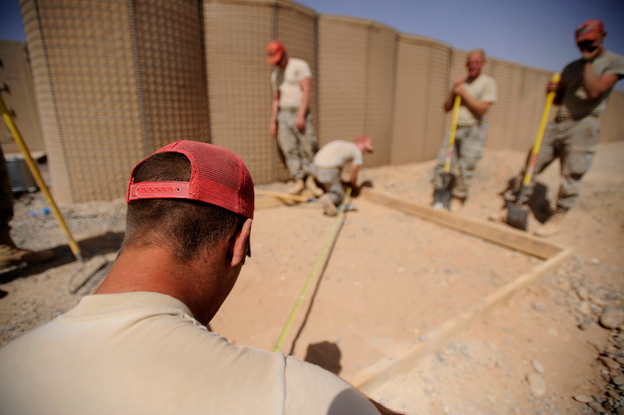 Airmen assigned to the 809th Expeditionary Red Horse Squadron, 1st Expeditionary Red Horse Group, level a concrete pad Sept. 9, Foward Operating Base Dwyer, Afghanistan. (U.S. Air Force Photo/Staff Sgt. Shawn Weismiller)