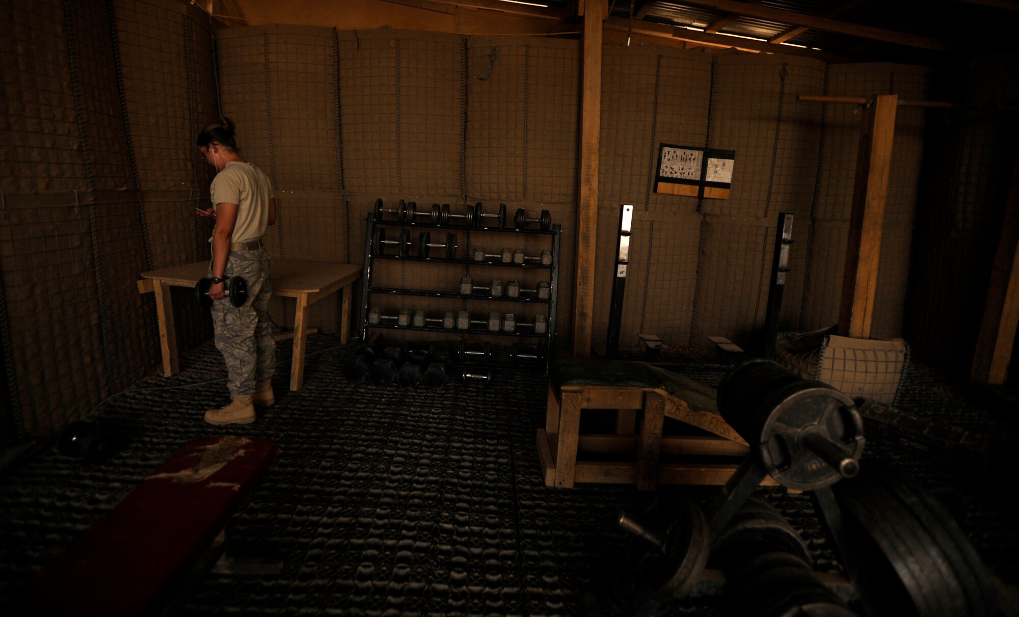 Senior Airman Emily Ferguson, assigned to the 809th Expeditionary Red Horse Squadron, 1st Expeditionary Red Horse Group, lifts dumbbells during her morning physical fitness routine Sept. 10., Forward Operating Base Dwyer, Afghanistan. Airman Ferguson is deployed from the 219th Red Horse Squadron, Air National Guard, Malmstrom, AFB, MT (U.S. Air Force Photo/Staff Sgt. Shawn Weismiller)