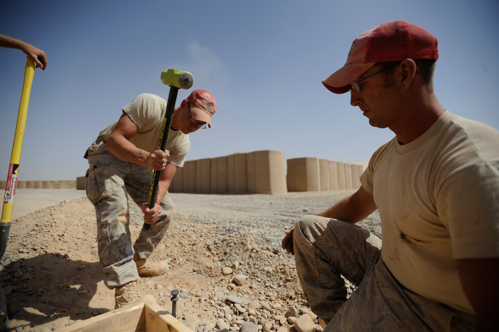 Left Staff Sgt. Johnathon Stone and Staff Sgt. Daniel Berner assigned to the 809th Expeditionary Red Horse Squadron, 1st Expeditionary Red Horse Group, hammer down stake for a cement pad Sept. 9, Forward Operating Base Dwyer, Afghanistan. Staff Sgt. Stone and Staff Sgt. Berner are deployed from the 819th Red Horse Squadron, Malmstrom, AFB, MT (U.S. Air Force Photo/Staff Sgt. Shawn Weismiller)