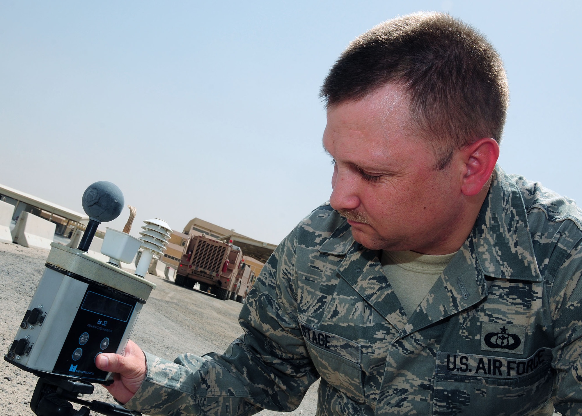 SOUTHWEST ASIA -- Tech. Sgt. Richard Stage, 386th Expeditionary Operations Support Squadron weather forecaster, checks the wet bulb globe temperature reading on a hs-32 area heat stress monitor at an undisclosed location in Southwest Asia Sept. 15, 2009.  Sergeant Stage is deployed from the 62nd Airlift Wing, McChord Air Force Base, Wash., and hails from Elmira, N.Y.  (U.S. Air Force photo/Tech. Sgt. Tony Tolley)